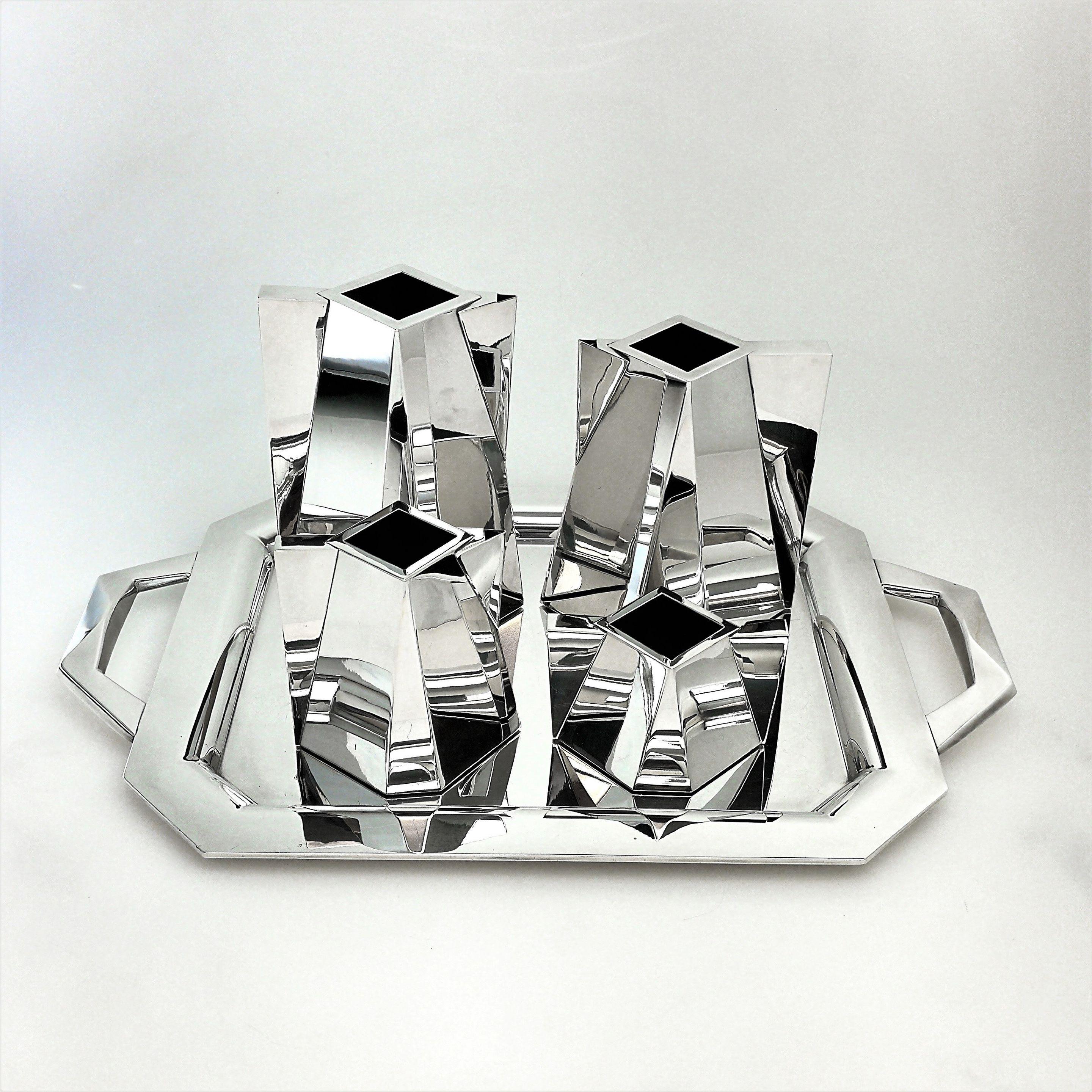 A spectacular sterling silver tea and coffee set on tray by Spanish master Silversmith Damian Garrido. This Tea Service is design incorporating modern geometric facets with an octagonal base narrowing into a square top and incorporated faceted