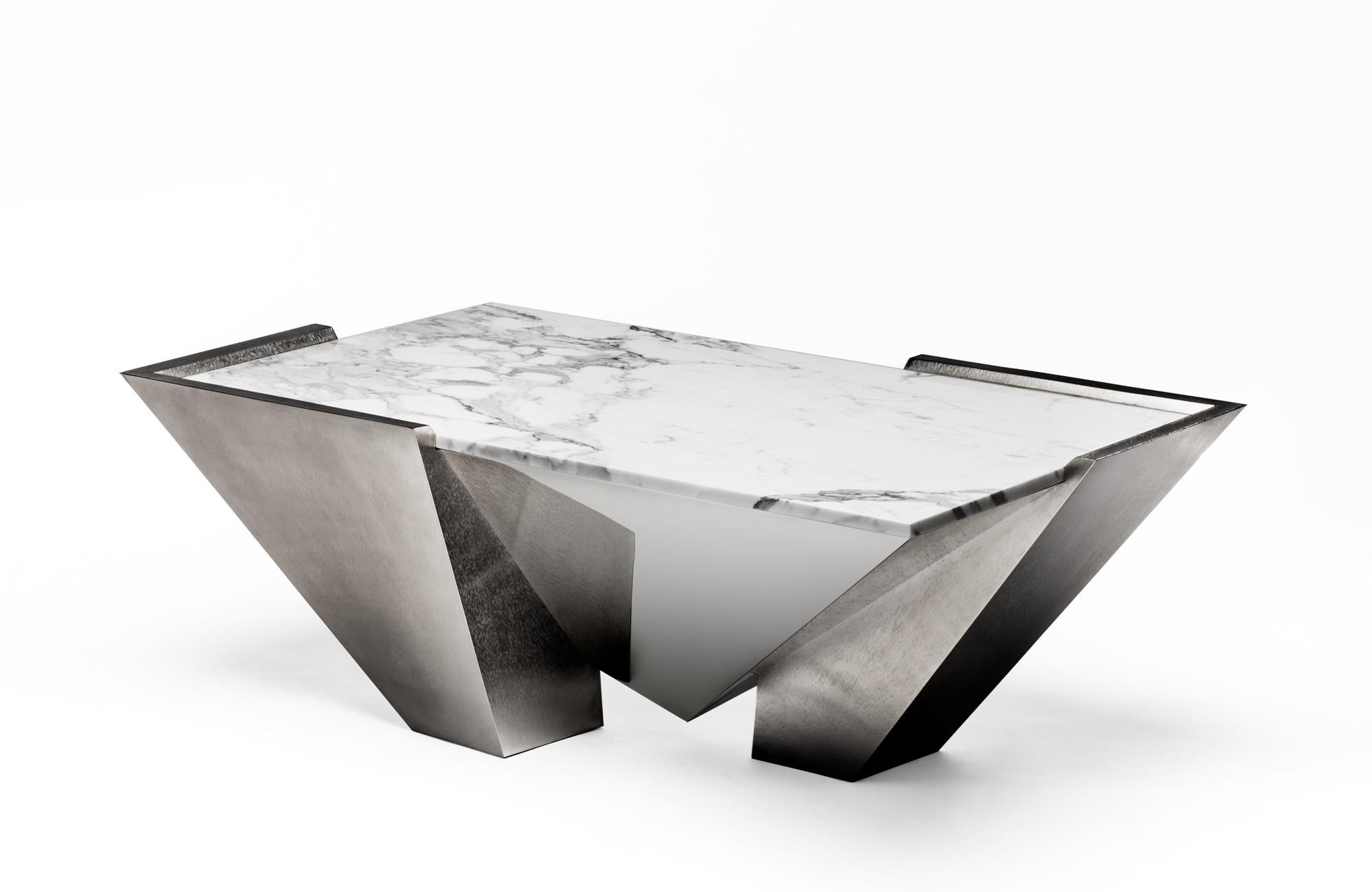 Lineal table, 2017
The Lineal table features an angular shape which catches the light from every angle and reflecting a soft shimmering glare. Crafted in nickel-plated metal, the facets of the table have been dyed in anthracite hue and treated with