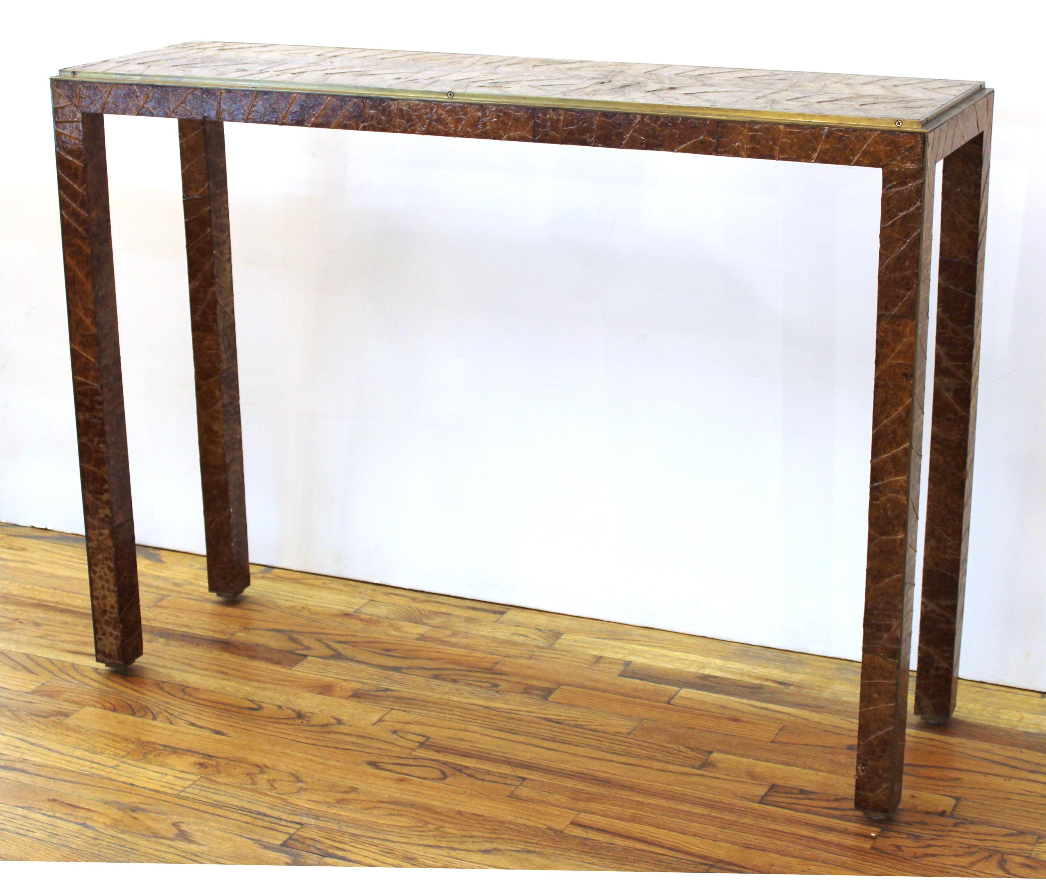Garrison Rousseau modern console table with applied tobacco leaves surface on top and legs. Makers plaque embedded on the bottom. Some restoration work to leaves layer on the top.