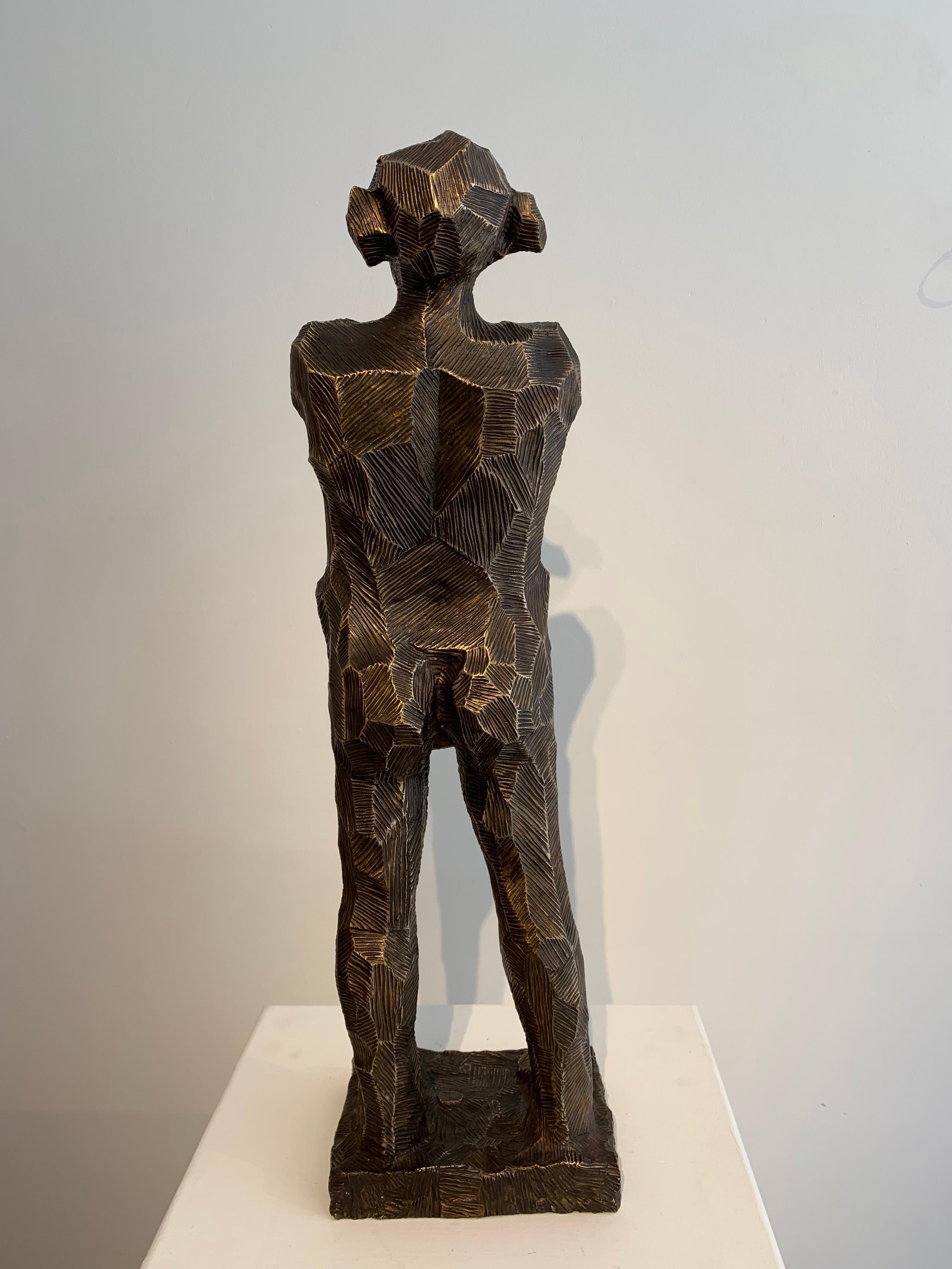 Man Holding Book by Gary Betts, bronze. 70cm high, 21cm wide, 15cm deep.  

Gary Betts is an English Sculptor, based in West London, currently working on a barge on the Thames. He first discovered his talent for ceramics and sculpture at school, so