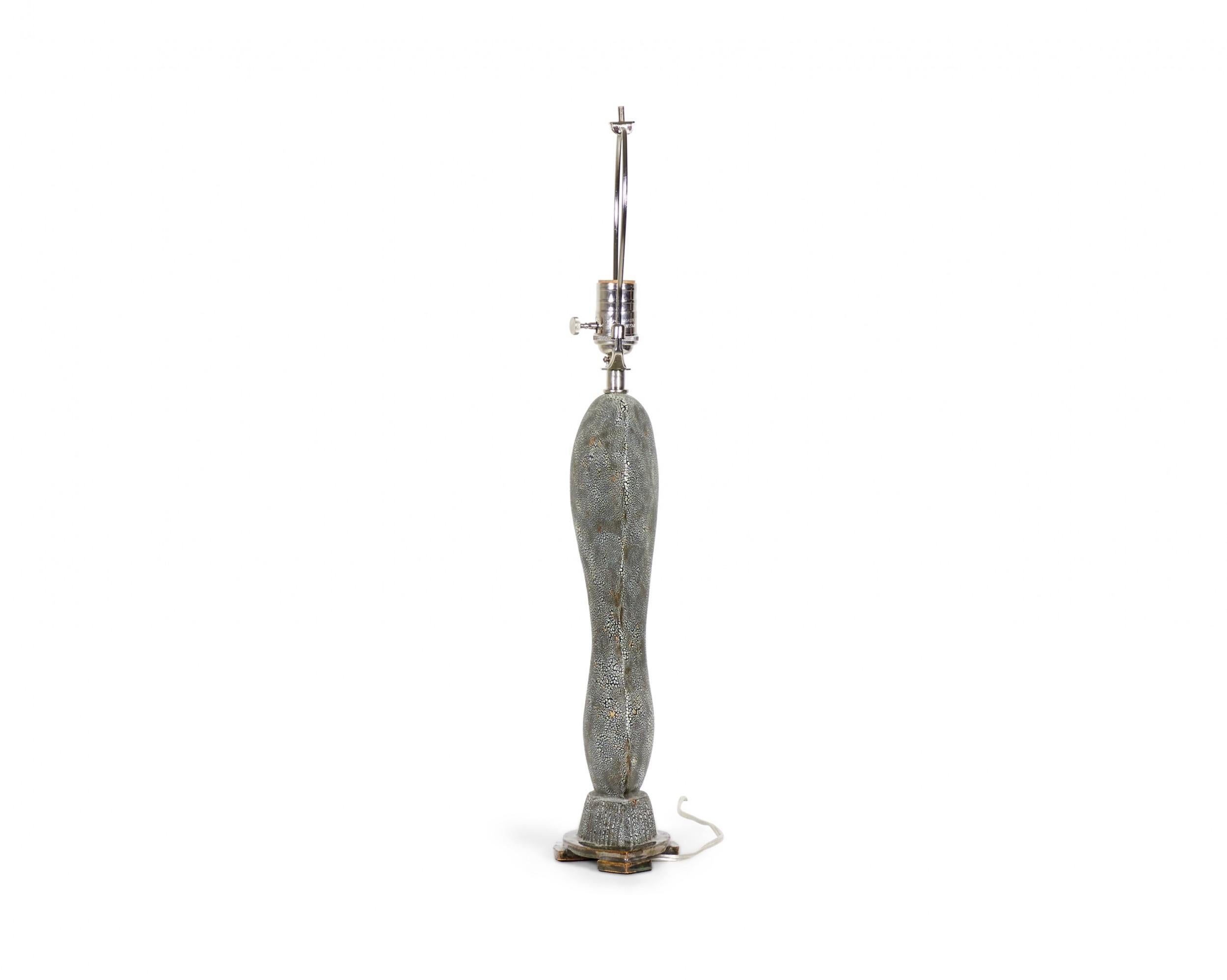 American Contemporary ceramic table lamp with an organic form and pebbled blue / black finish, topped with a heather gray drum shade. (GARY DIPASQUALE) (Similar to GRL4873)
