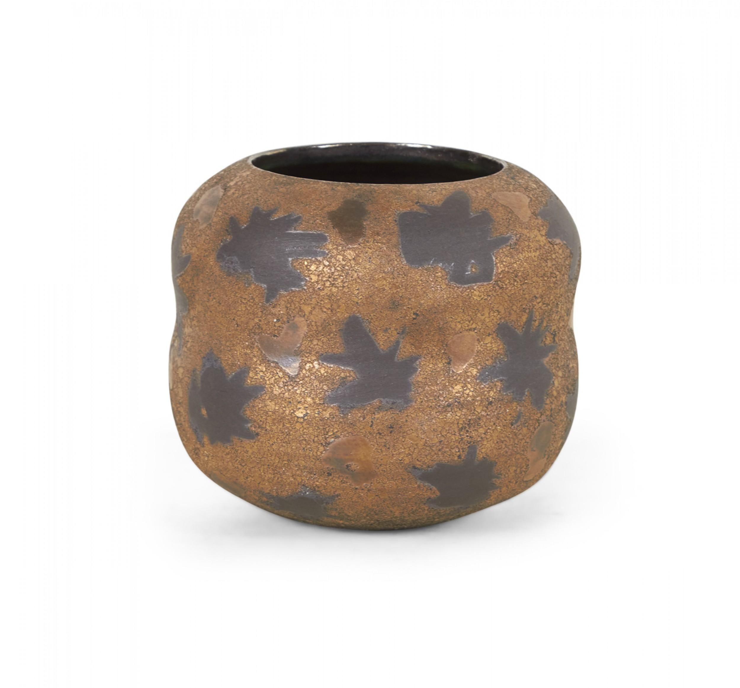 Contemporary thrown clay vase with a wide curved form with indented waist, a rounded lip and circular opening, and a black starburst pattern against a bronze and black textured glaze. (GARY DIPASQUALE).