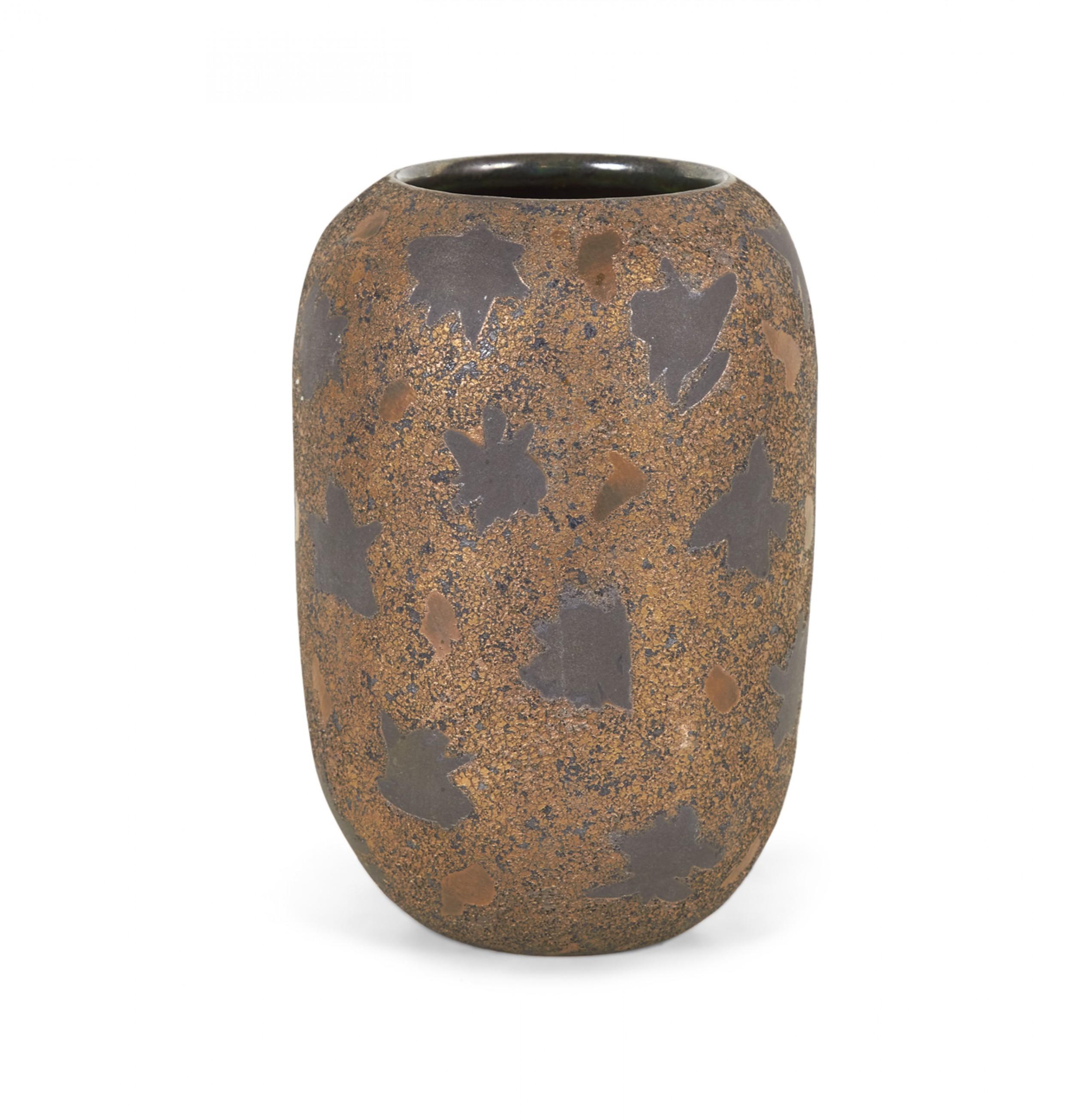 Contemporary thrown clay vase with a cylindrical form with a rounded lip and circular opening, and a black starburst pattern against a bronze and black textured glaze. (GARY DIPASQUALE).