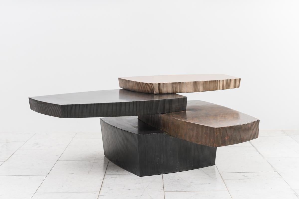The level planes of Gary Magakis’ handmade, unique bronze and steel stacked low table with drawer reference the centuries-old stone walls that populate Magakis’ rural surroundings in Pennsylvania. The dense forms of the table are stacked in a