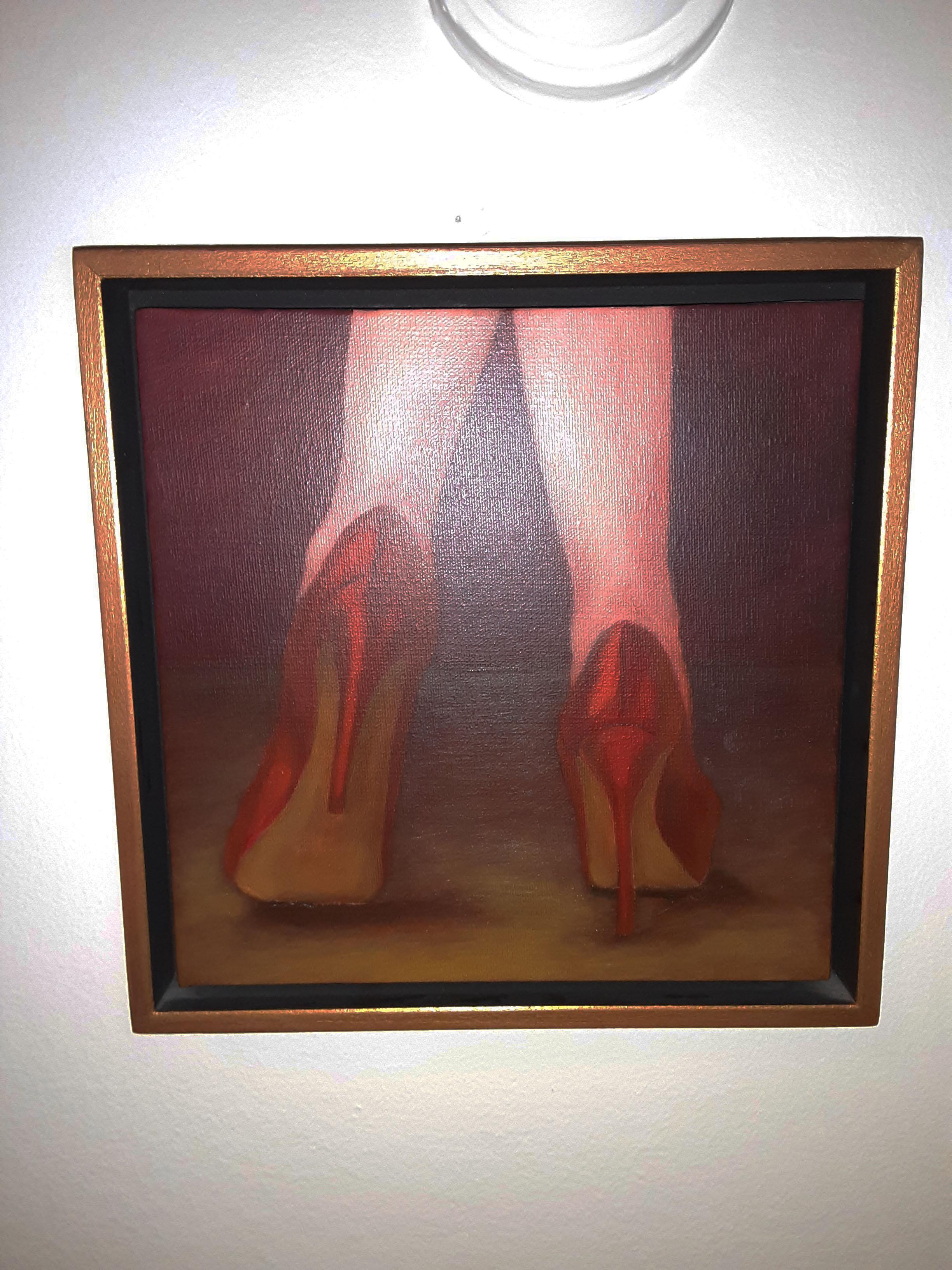 This oil on canvas painting features a beautifully formed pair of women's legs in classic red stiletto heels. The background of the painting also shares these same red tones adding to the almost romantic and warm nature of the work. The painting is
