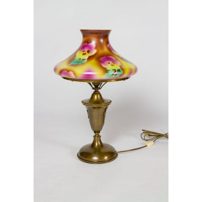 Antique brass restored gas lamp. Tam o shanter style glass shade with purple, yellow, brown, and green pansy design.

Material: brass, glass
Style: Victorian,Traditional
Place of Origin: United States
Period made: Early 20th