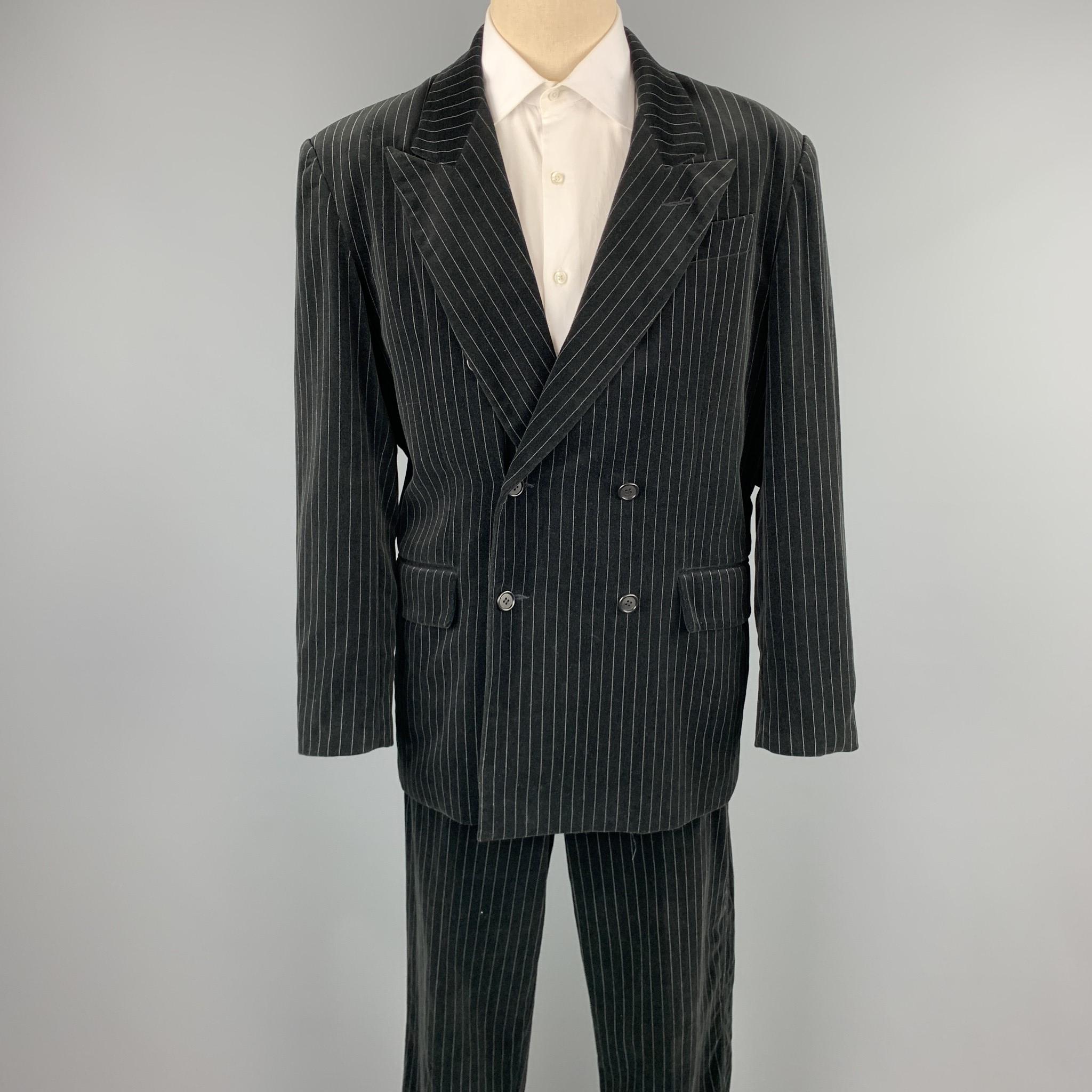 GASPAR SALDANHA suit comes in a black stripe velvet and includes a double breasted breasted button sport coat with a peak lapel and matching flat front trousers. Made in USA.

Very Good Pre-Owned Condition.
Marked: