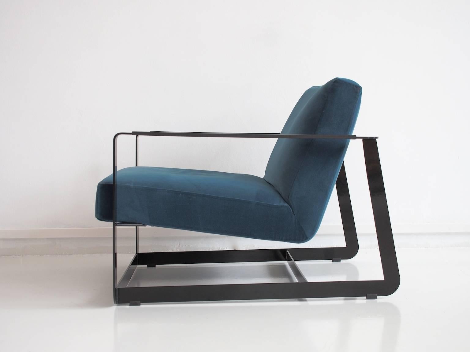 Contemporary armchair, model Gaston, designed in 2008 by Vincent Van Duysen and manufactured by Poliform, Italy. Metal frame varnished in black, upholstered in blue velvet fabric. Cushion with manufacturer's embossing on underside and cushion with