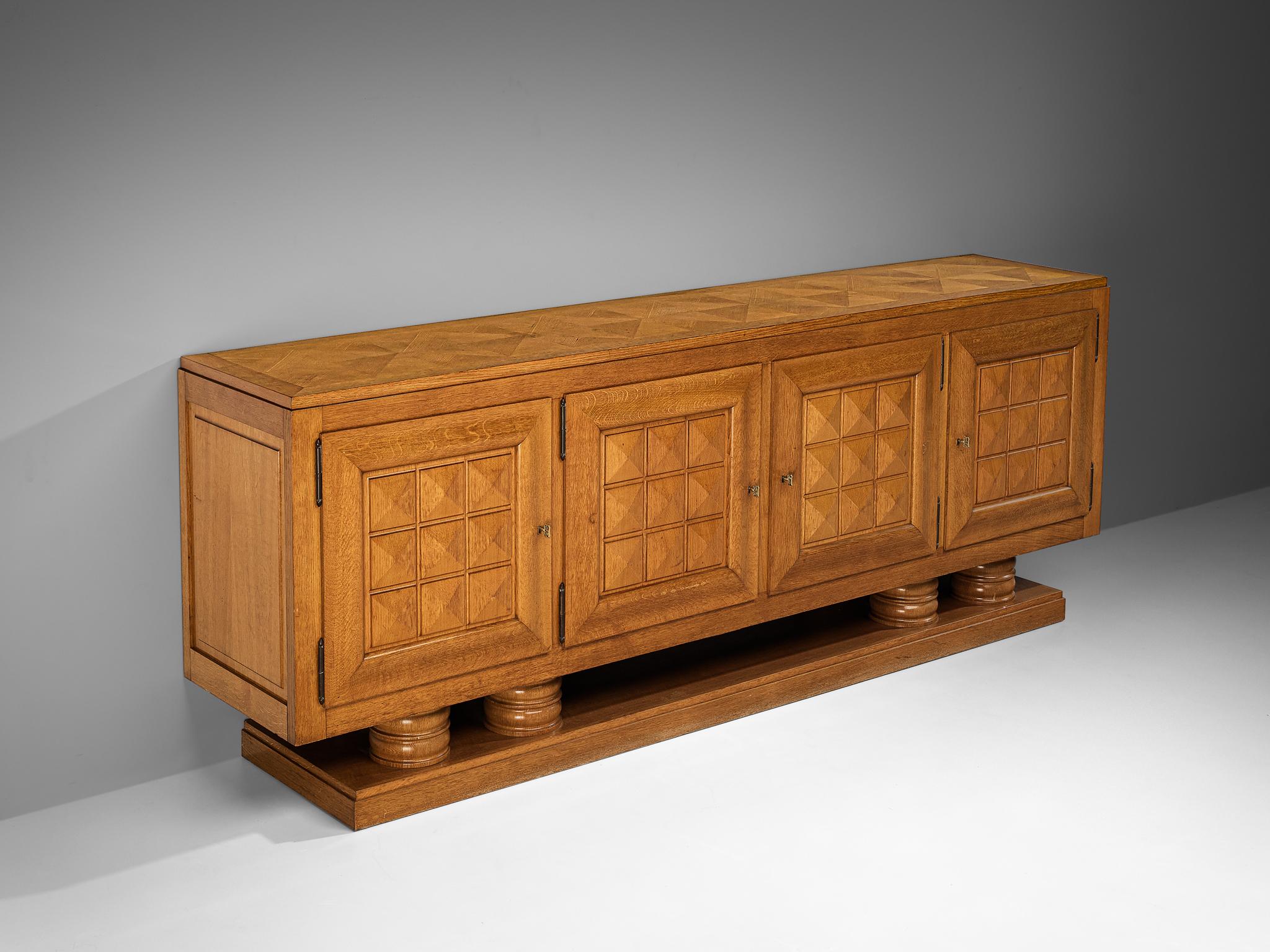 Gaston Poisson, sideboard, oak, oak veneer, France, 1940s

Crafted by French designer Gaston Poisson within the realm of Art Deco, this sideboard is a testament to the designer's exceptional craftsmanship and great eye for detail. The doorpanels
