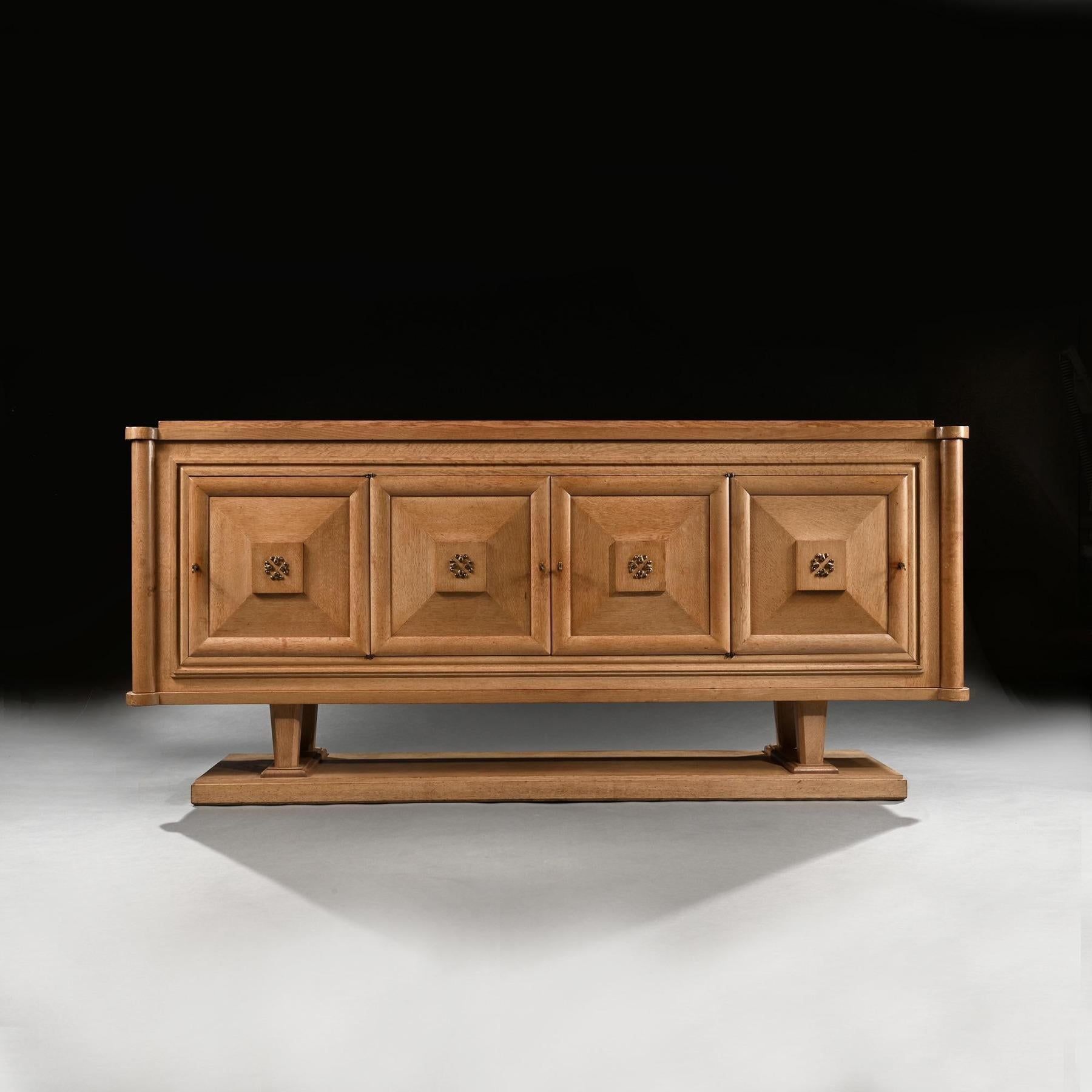 A very chic and well constructed French Art Deco cerused / bleached natural oak sideboard, designed by Gaston Poisson.

France Circa 1930 -1940.

This stylish sideboard has a stepped oblong top with lobed corners having a central reserve inlaid