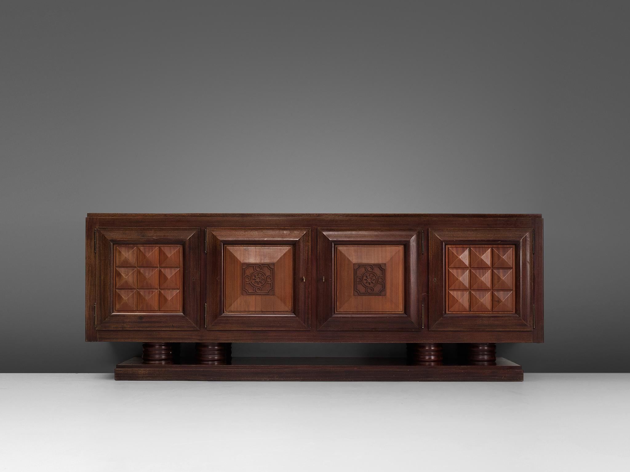 Gaston Poisson, credenza, in cedar, mahogany, France, 1930s. 

Sturdy credenza in oak with graphical door panels and parquet top. This four-door sideboard is equipped with several shelves and drawers which provide plenty of storage space. The