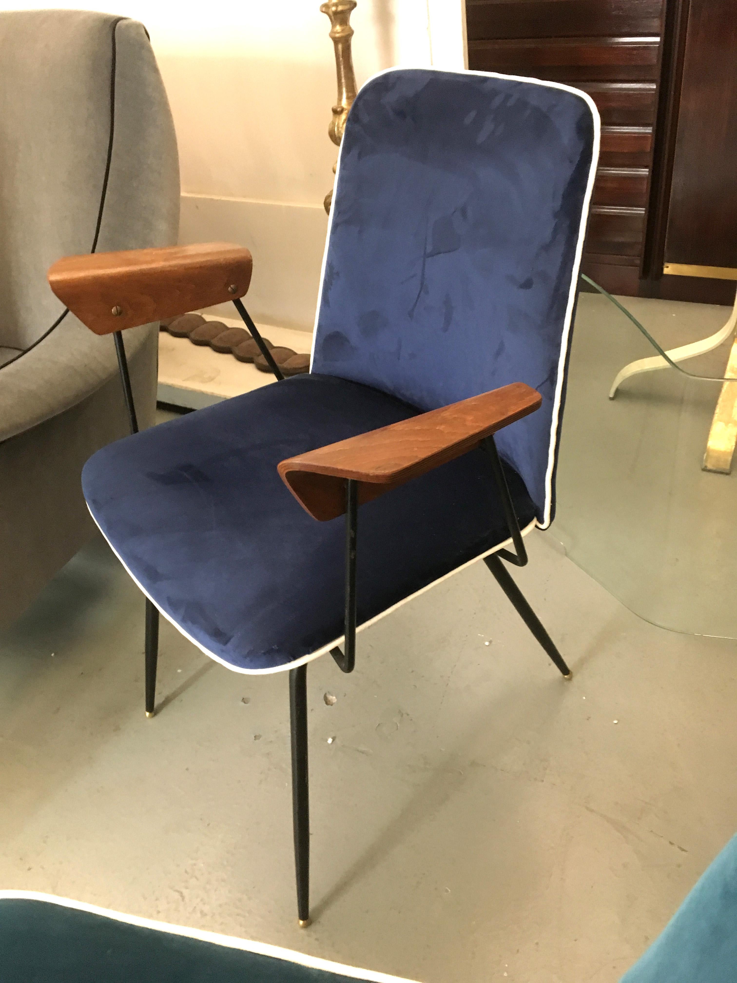 Rare Du22 chairs by Gastone Rinaldi for RIMA with plywood armrest and new blue upholstery on a black metal base. The model was first presented during the 1951 Fair of Arts and Industrial Aesthetics in Milan. Published in 