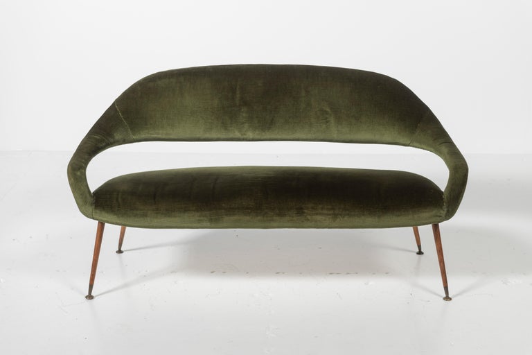 This incredibly sleek and rare mid century sofa is designed by esteemed Italian, Gastone Rinaldi for RIMA, 1950. Elegant lines, this piece both floats and grounds the room. In very good condition and can be easily reupholstered if desired.