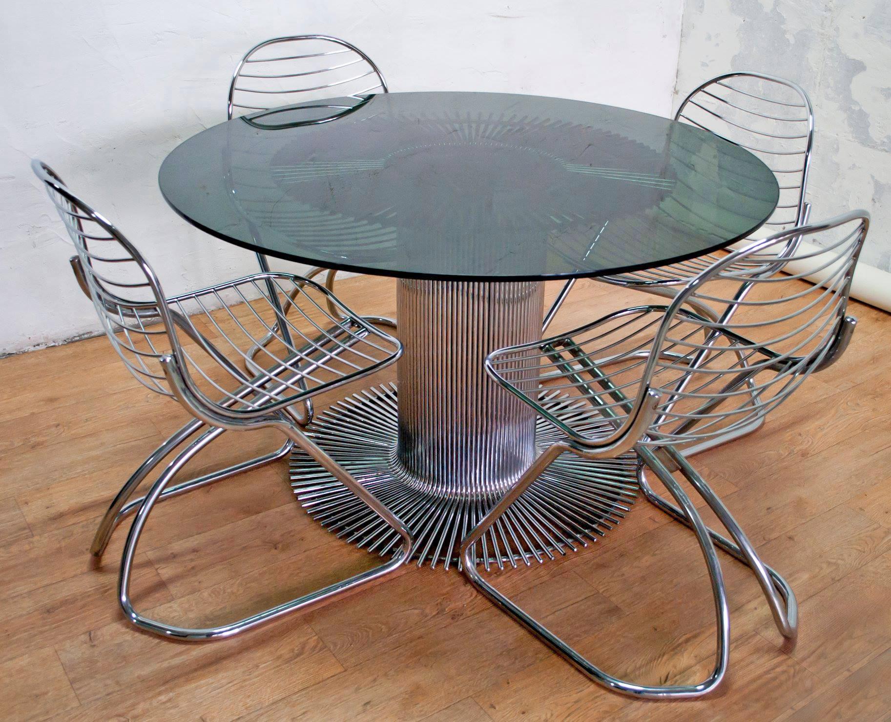 This dining set was designed by Gastone Rinaldi for Rima in the 1970s, and consists of a table in chromed metal with smoked glass, and four chairs in chromed metal.

The Italian designer Gastone Rinaldi was born in Italy, in Padua, in 1920; his