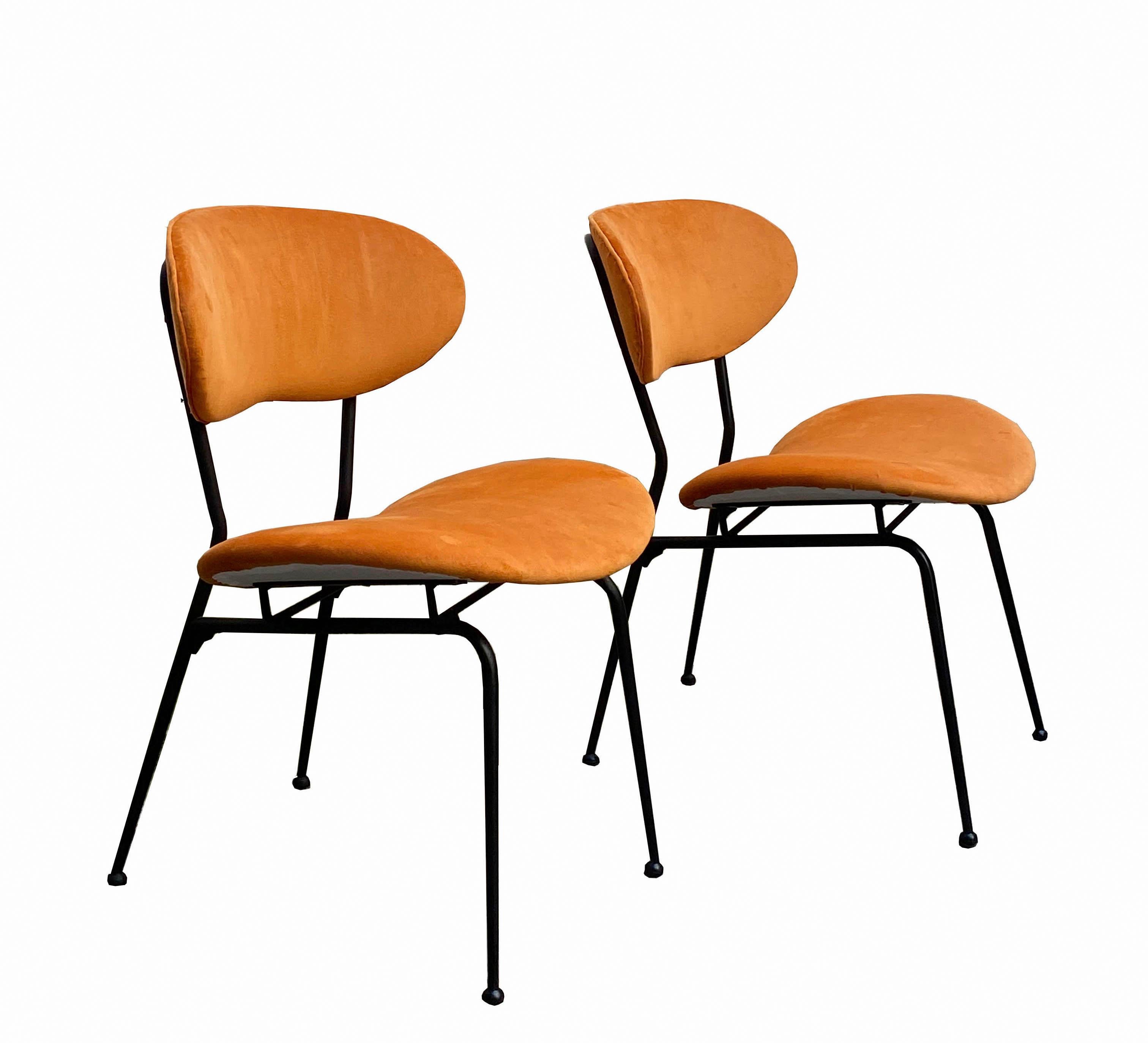 Set of 2 dining chairs by Gastone Rinaldi with black enamelled metal frame, anatomical seats and backs upholstered in light orange velvet. Produced by Rima in Italy in the 1950s.