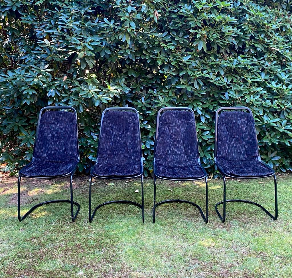 Gastone Rinaldi, set of four black highback dining chairs, Ca. 1970s. Wonderful Italian design dining room chairs with black metal base and dark colored fabric cushions. The chairs remain in good condition with some pins repaired. Further, normal