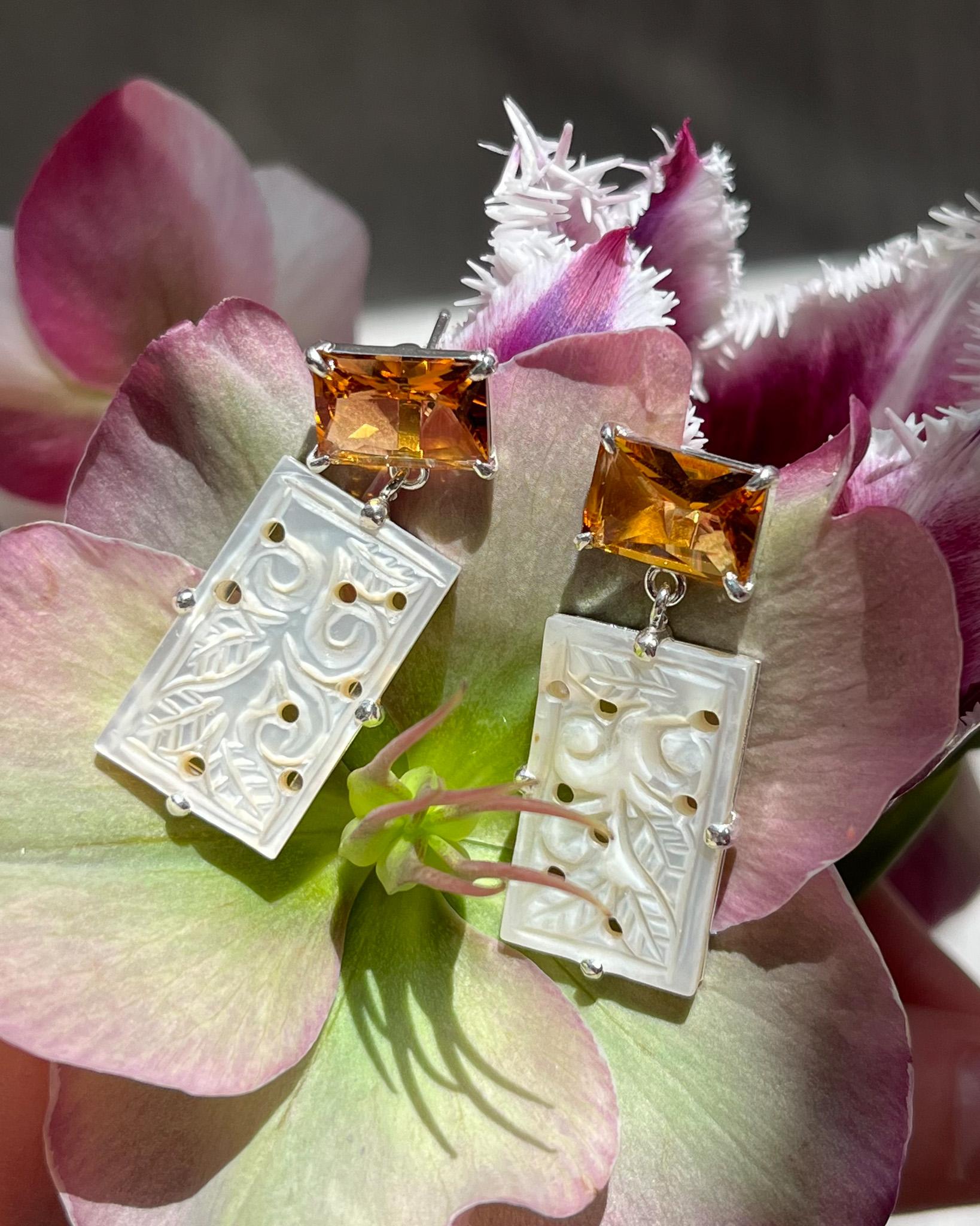 Intention: Opening doors

Design: Small yet packing a big punch, these glowing dangle earrings are perfect for spring. Fresh emerald-cut orange quartz and floral, iridescent hand-cut mother of pearl remind us that new doors are always opening.