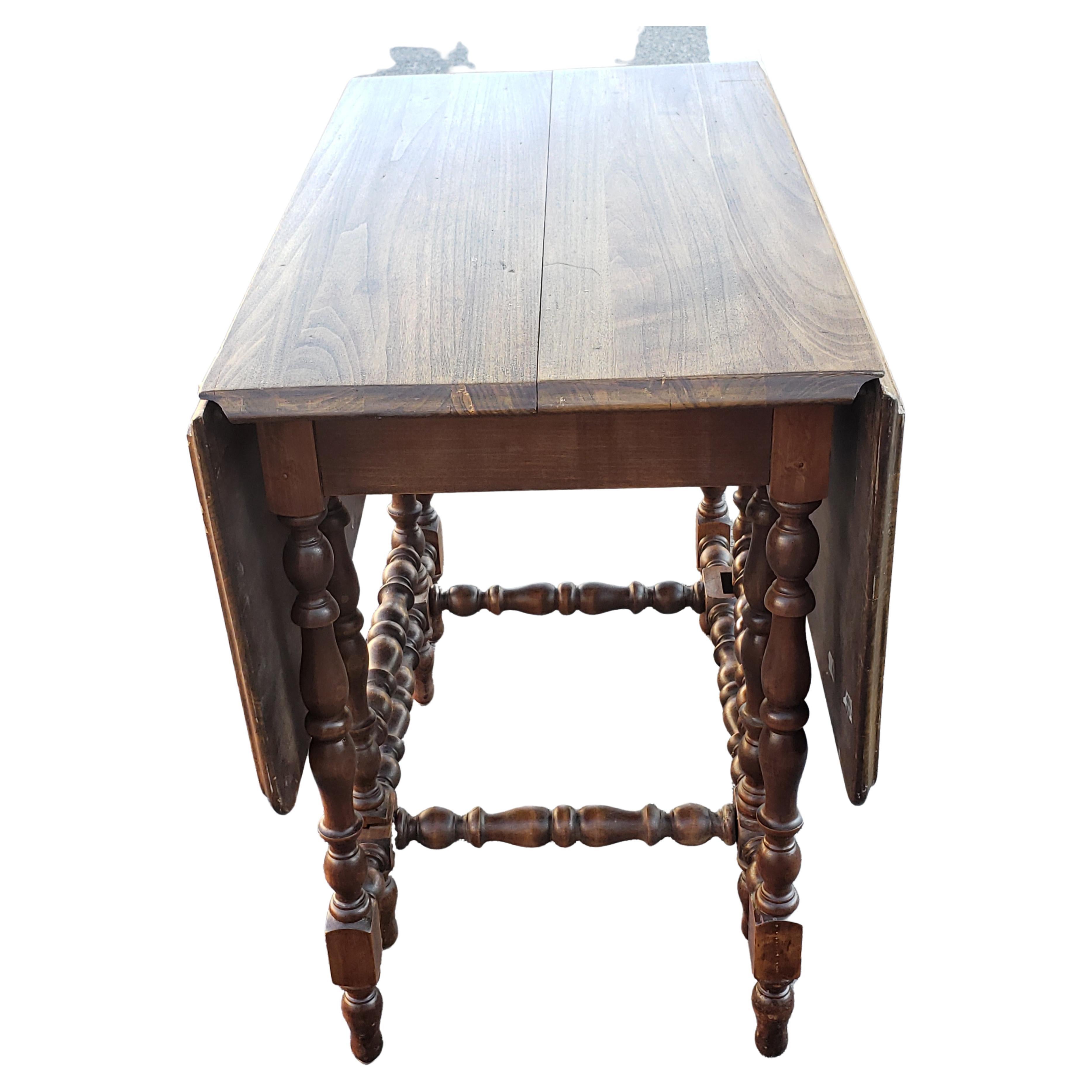 Awesome antique gateleg drop leaf table, amazing turned legs,, wonderful old patina! Perfect for a farmhouse. Made walnut wood and it is very old. This item is in good vintage condition with some wear appropriate with age and normal use. Perfect for