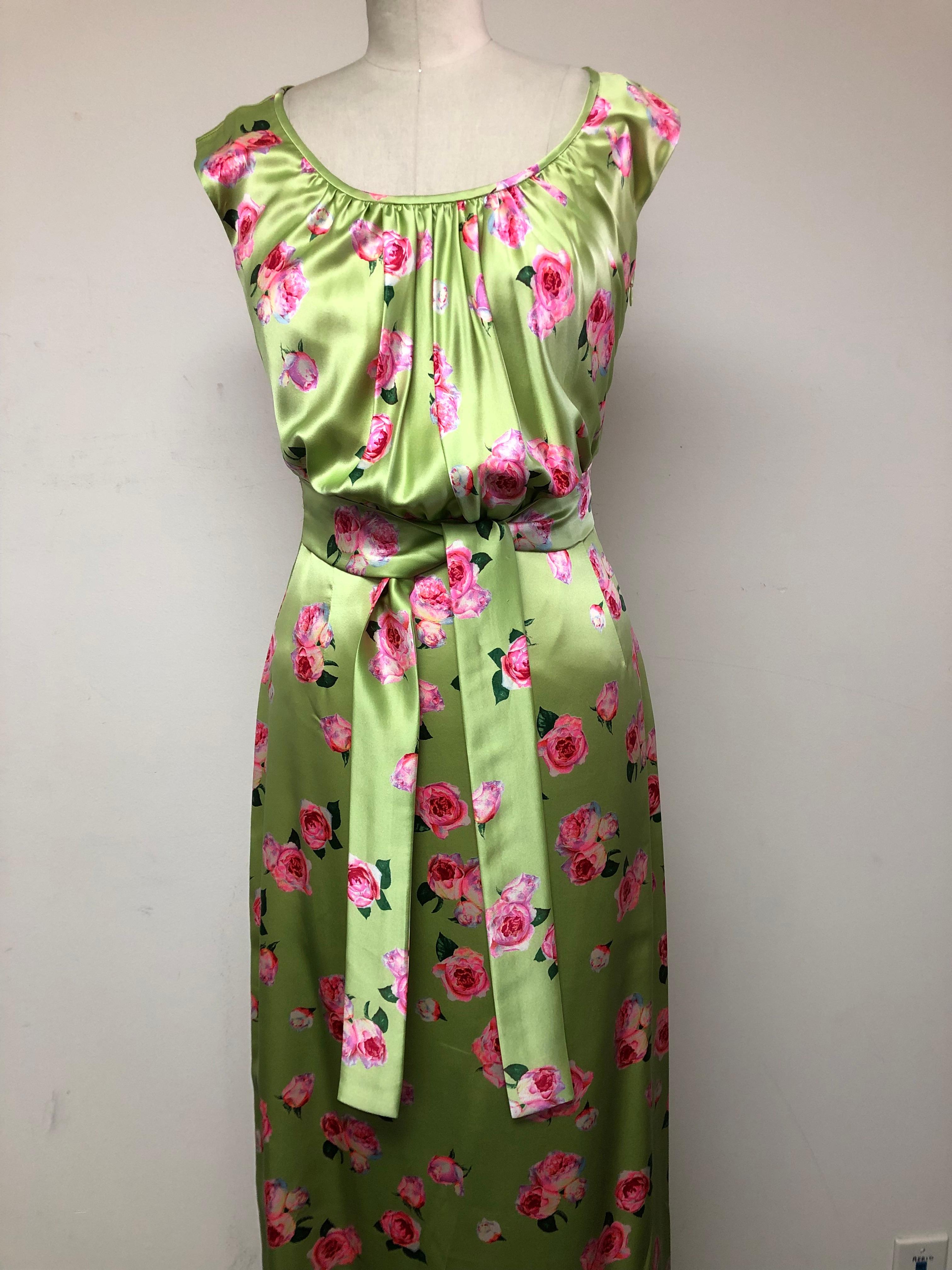 100% Silk Charmeuse from Frontline Zurich..maker of Hermes scarves.
Delightfully animated pink roses scattered 
throughout the pale green blouson dress. Front self tie belt which can also be tied in back. The blouson bodice 
and soft drape is a wink