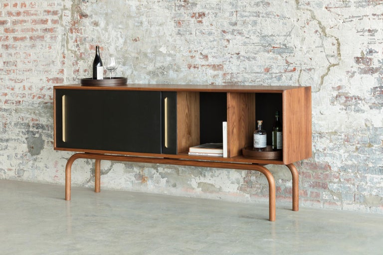 Gatsby Credenza is exquisitely handcrafted. The legs are long continued and unified bending wood. Inspired by the history and influences of the Prohibition era in the United States, Gatsby Credenza is designed to store liquors, records, and books.