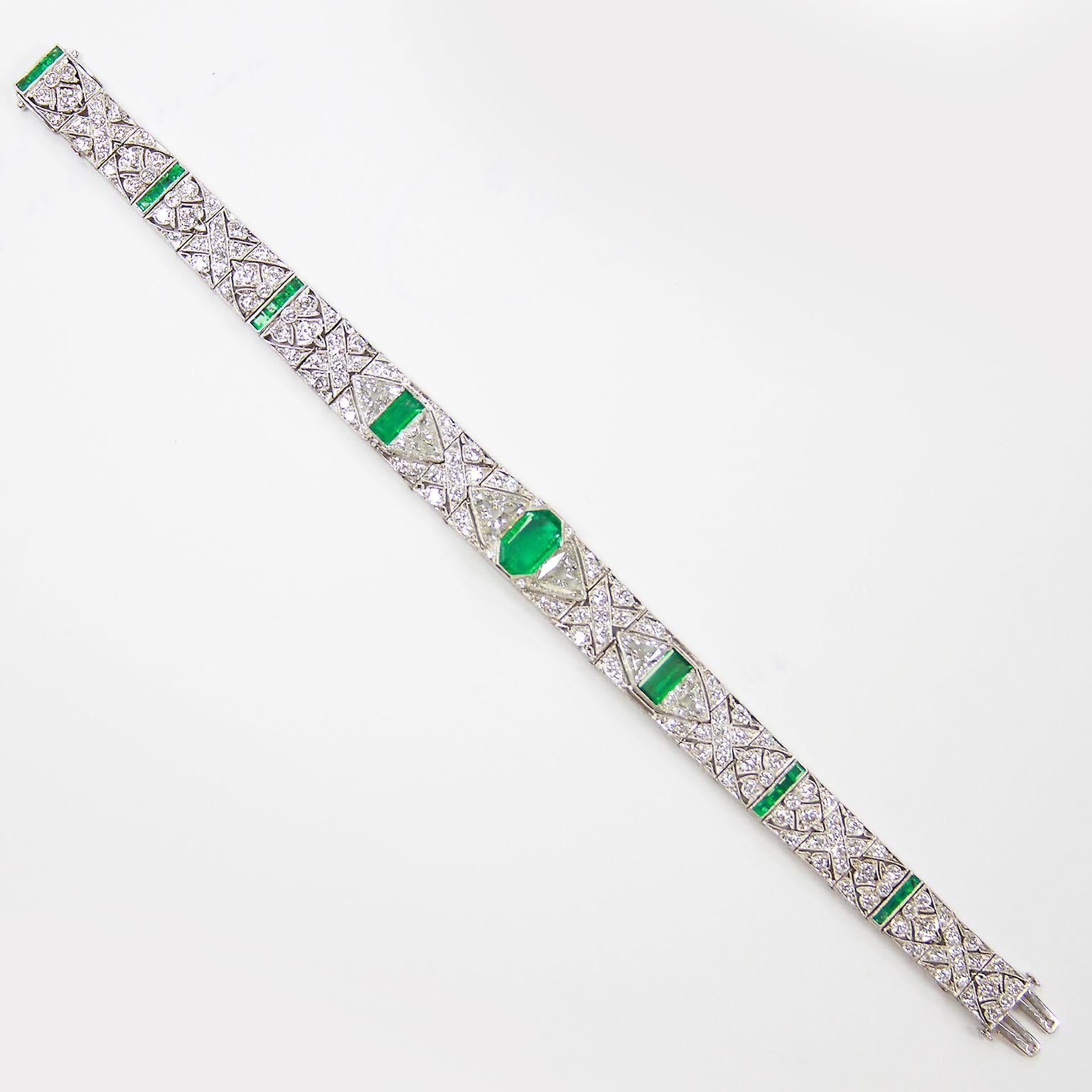 An original Art Deco period bracelet by Gattle & Co. set with three Colombian emeralds and various shapes of diamonds forming classical deco patterns. Center emerald measures 10.00 x 6.05 x 2.80 mm. Emerald is a bright transparent green. Other two