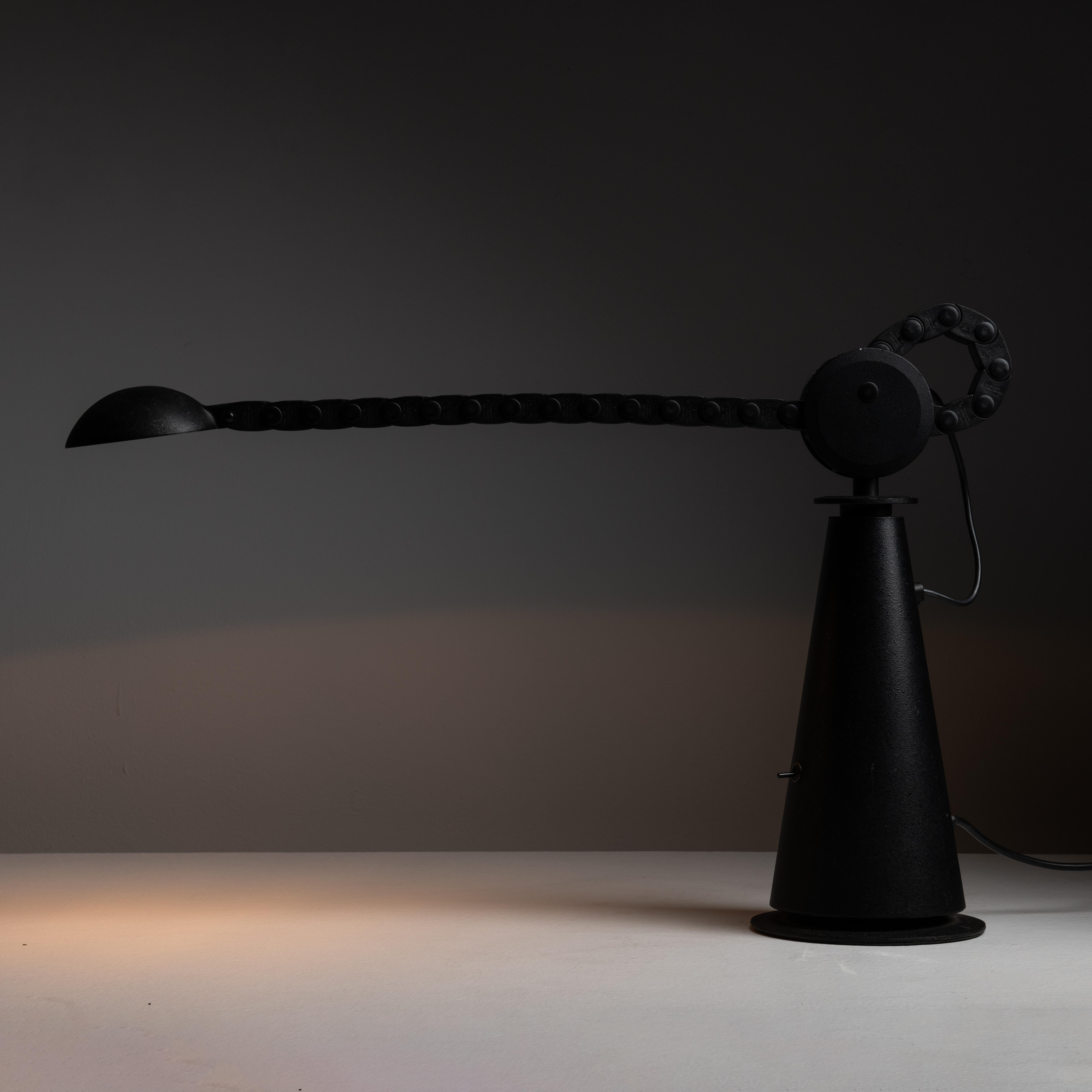 Gaucho table lamp by Studio PER for Egoluce. Designed and manufactured in Italy, circa 1980. Unique industrial table lamp made of tempered steel with black finish. The lamp is depth-adjustable with a belt mechanism that composes the neck of the