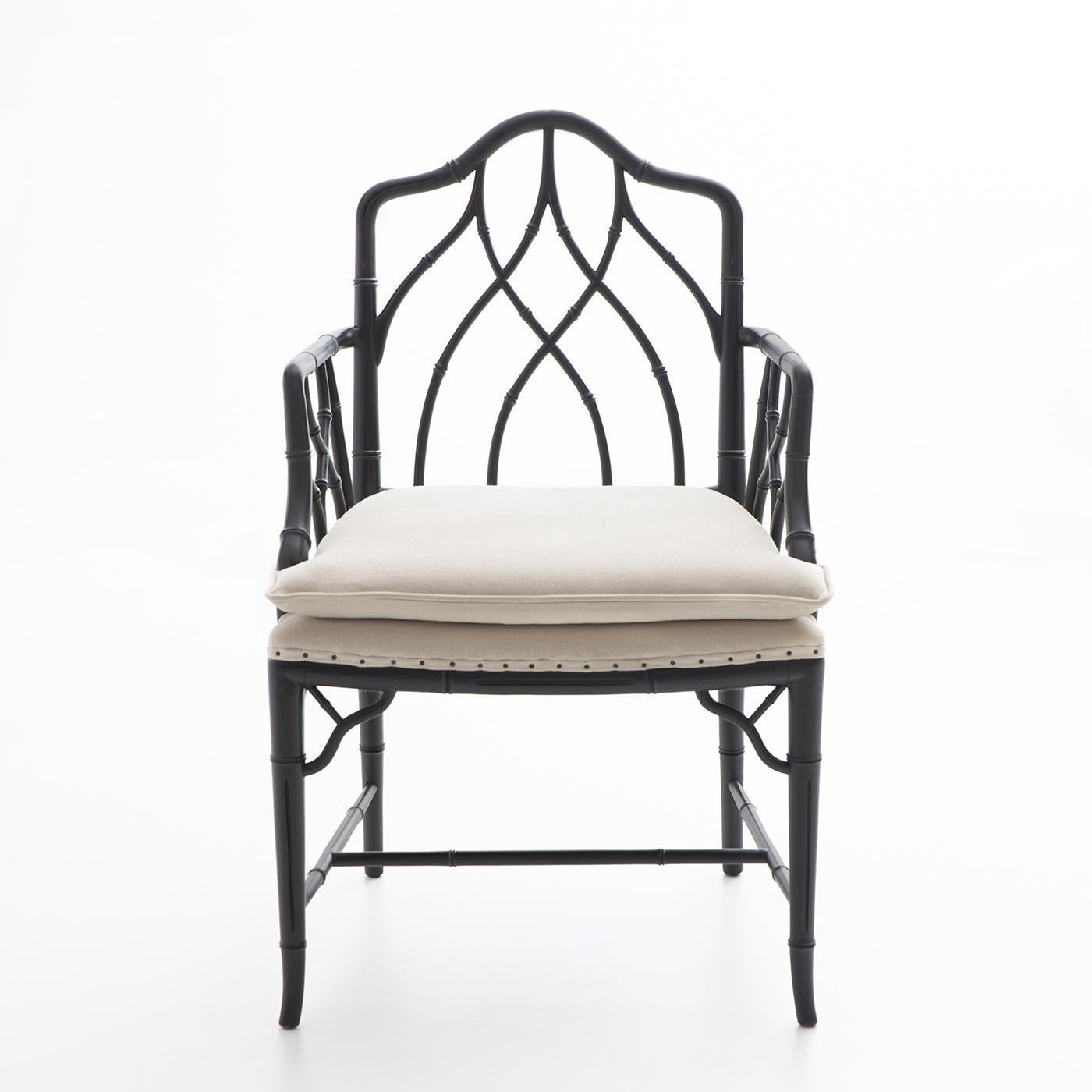 This superb, 19th century-style armchair stands out for its graceful combination of materials and artisan techniques. A sinuous array of branches defines the beech frame, which boasts a singular bamboo-like design peeled and lacquered in black to