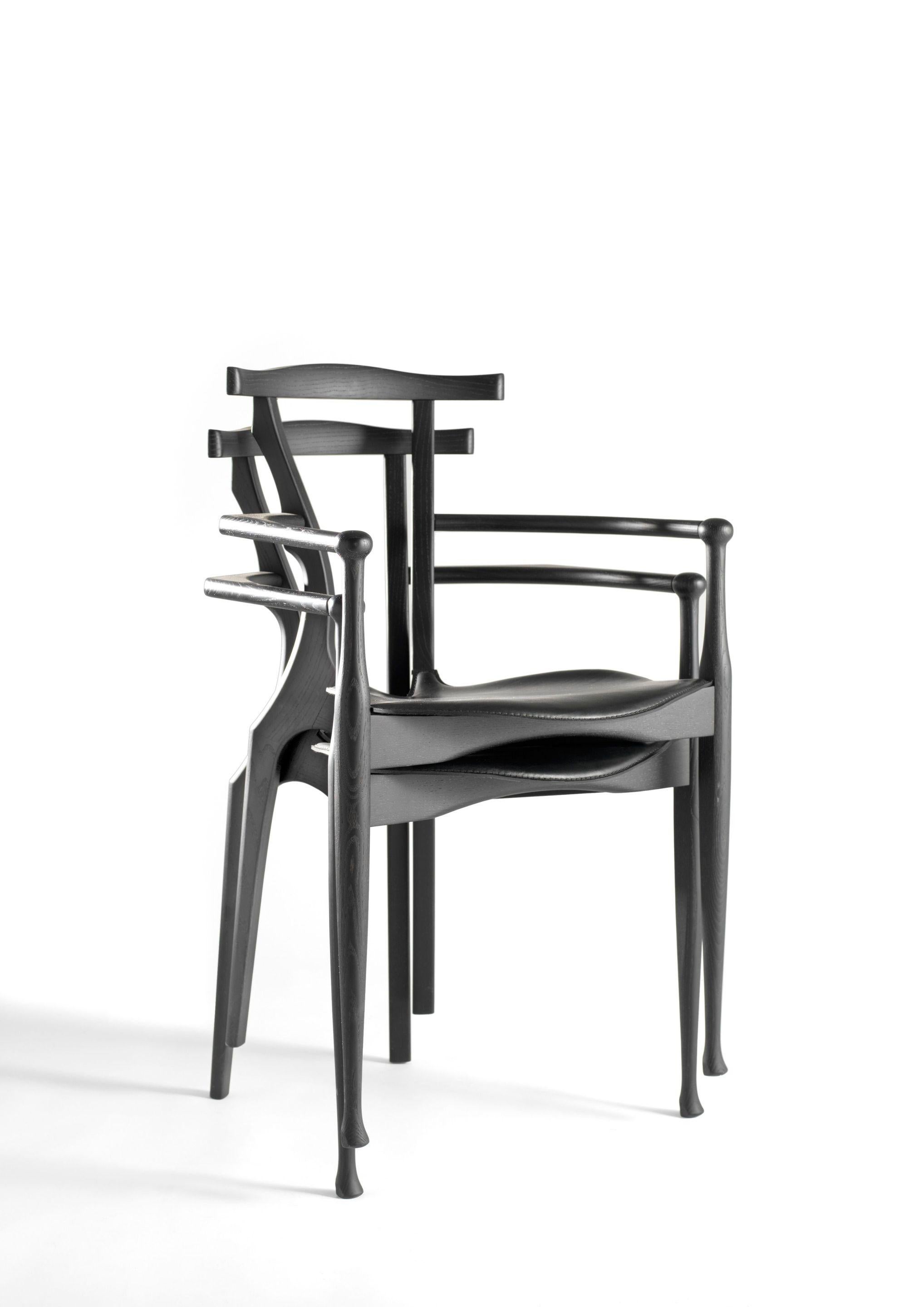 Gaulino chair by Oscar Tusquets
Dimensions: D 51 x W 55 x H 84 cm 
Materials: structure and backrest in solid natural ash, lacquered in black or varnished. Seat upholstered in natural or black leather.
Available in black.


The chair is made