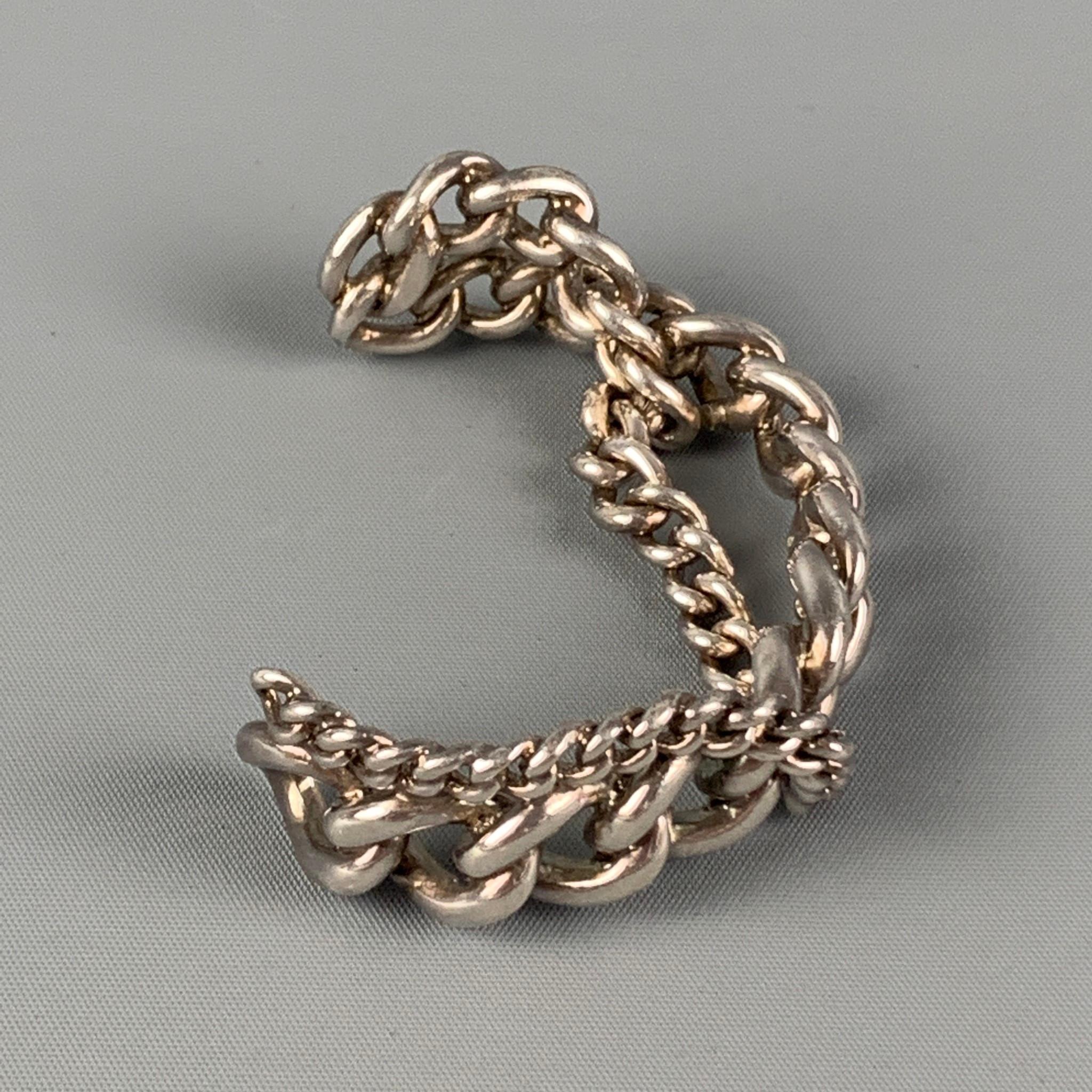 GAULTIER cuff bracelet comes in a silver tone chain link metal. 

Very Good Pre-Owned Condition. 

Measurements:

Width: 0.75 in.
Fits: 2.75 in. 
