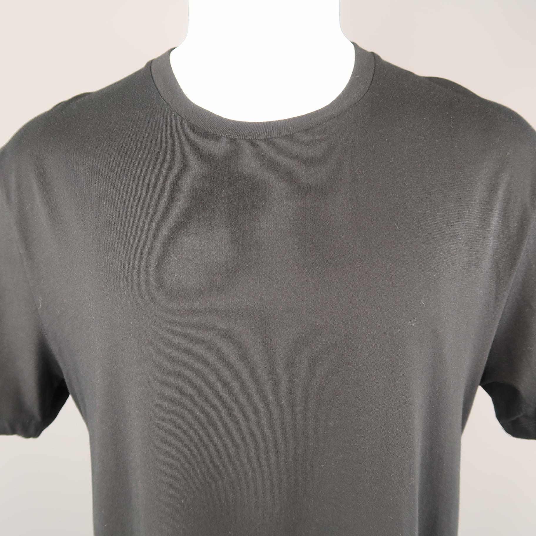 GAULTIER2 by JEAN PAUL GAULTIER oversized T shirt comes in black cotton jersey with short sleeves, crewneck, and high slit sides. Made in Italy.
 
Excellent Pre-Owned Condition.
Marked: XS
 
Measurements:
 
Shoulder: 21 in.
Chest: 46 in.
Sleeve: 9.5