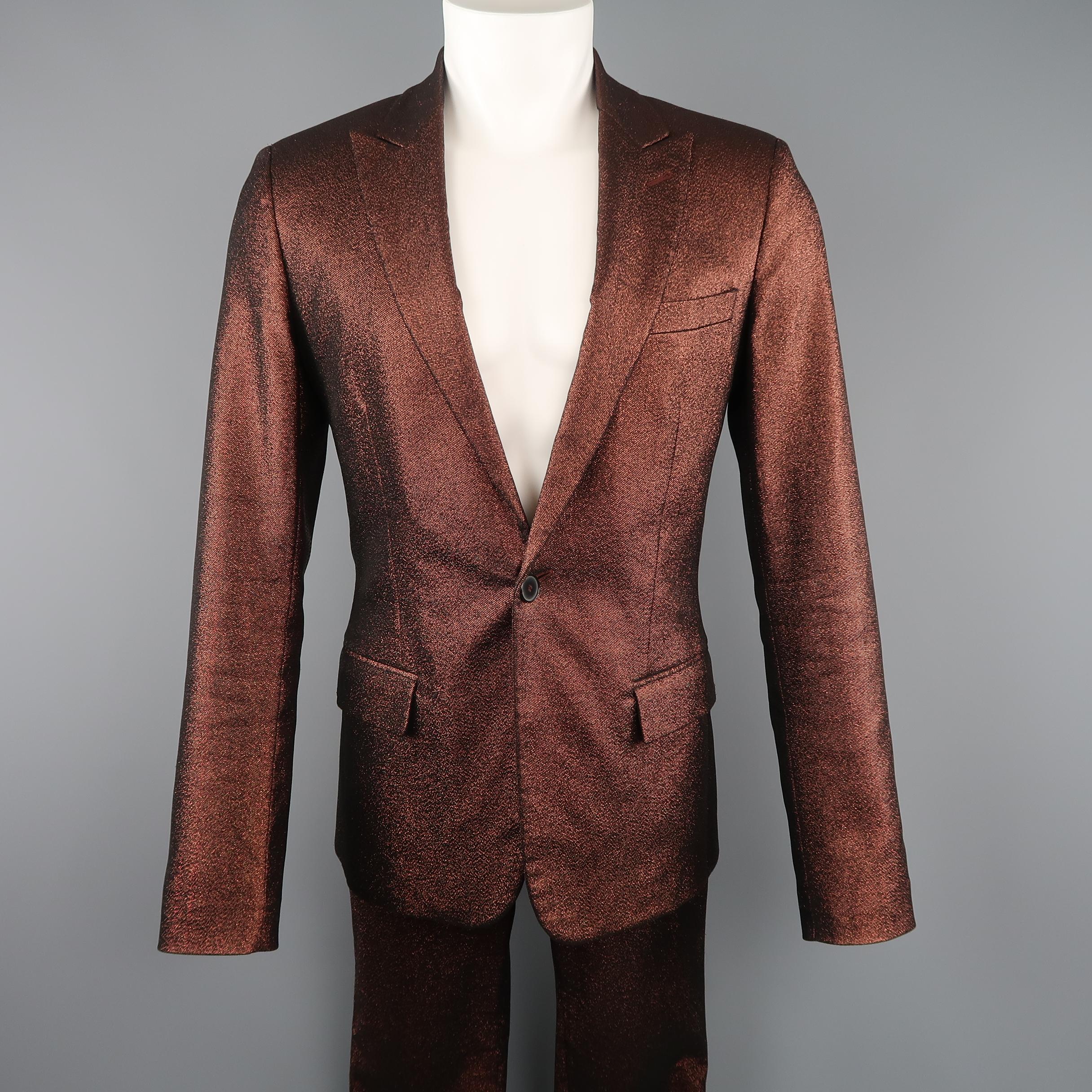 Vintage GAULTIER 2 by JEAN PAUL GAULTIER suit comes in a copper metallic sparkle fabric and includes a single breasted, peak lapel, one button slim tailored sport coat and matching skinny trousers. Made in Italy.
 
Excellent Pre-Owned