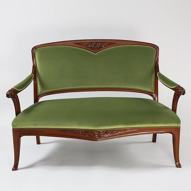A French settee by Camille Gauthier & Paul Poinsignon. The settee in mahogany has carved stylized flowers on the back, arms and below the seat. Upholstered in green fabric. 

(MG #17526)

 