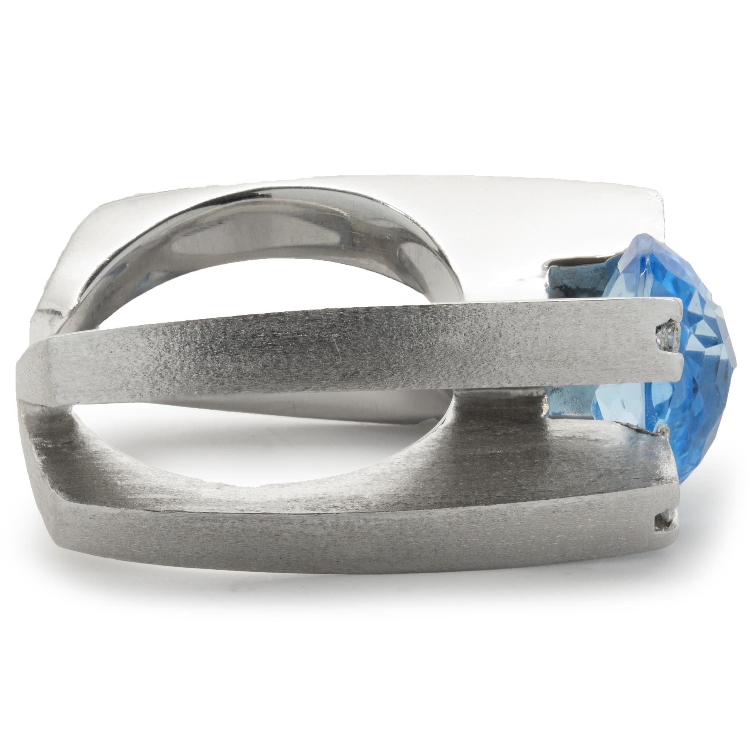 Designer: Gauthier
Material: 14K white gold
Diamond: 8 round brilliant cut = .24cttw
Color: G
Clarity: VS2
Blue Topaz: 1 checker board cut oval = 5.78ct
Weight:  24.31 grams
Dimensions: ring top measures 13mm wide
Size: 8 (complimentary sizing