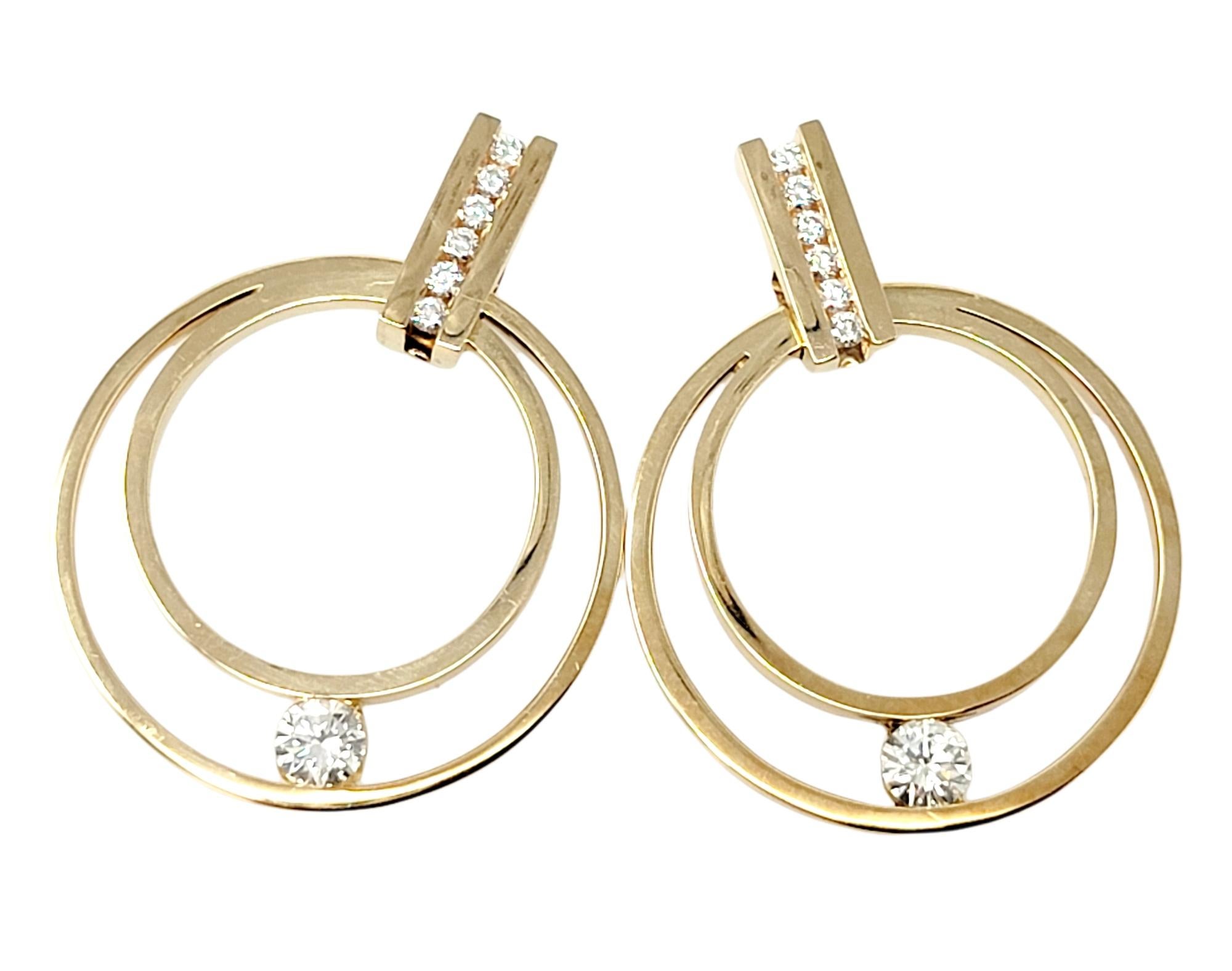 We absolutely love these gorgeous modernized hoop earrings with exquisite diamond detailing by jewelry designer Gauthier. The top portion features a vertical bar link with channel set round diamonds, while the dangling double hooped bottom features