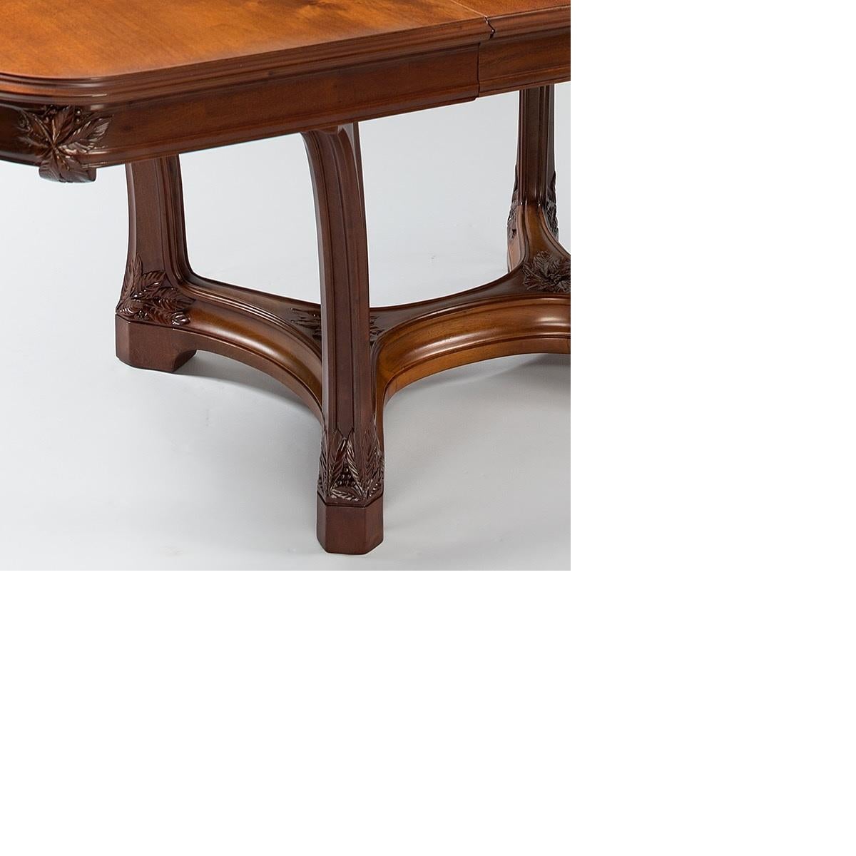 This full dining suite by Camille Gauthier & Paul Poinsignon includes a mahogany dining table with two custom leaves, a set of six mahogany dining chairs with floral tooled leather and brass tacks, and a mahogany sideboard with accompanying mirror,