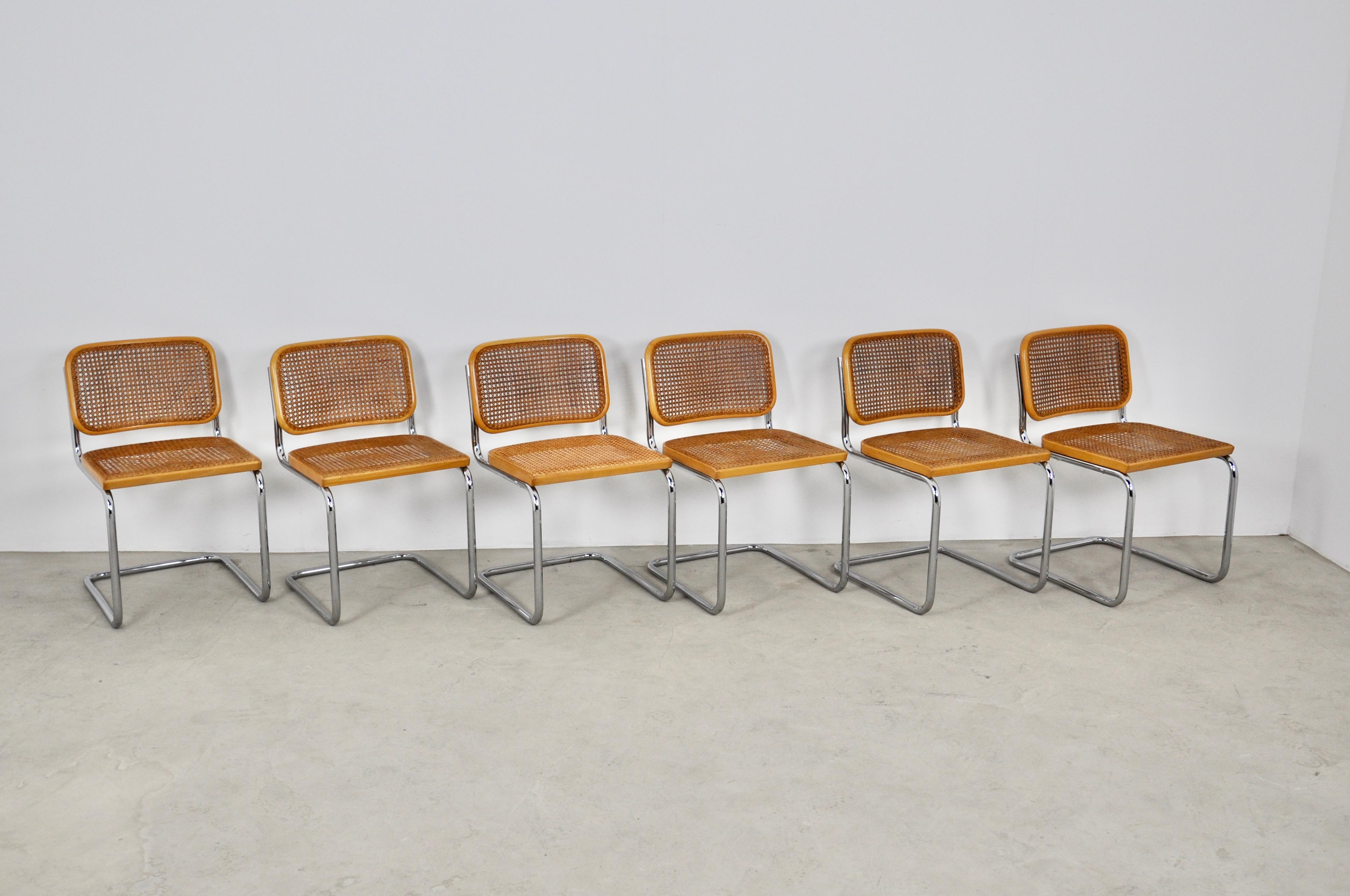 Series of 6 chairs in chromed metal, wooden structure in wood color and wickerwork. wear due to the time and the age of the chairs. Measures: Seat height 46cm. Stamped Gavina.