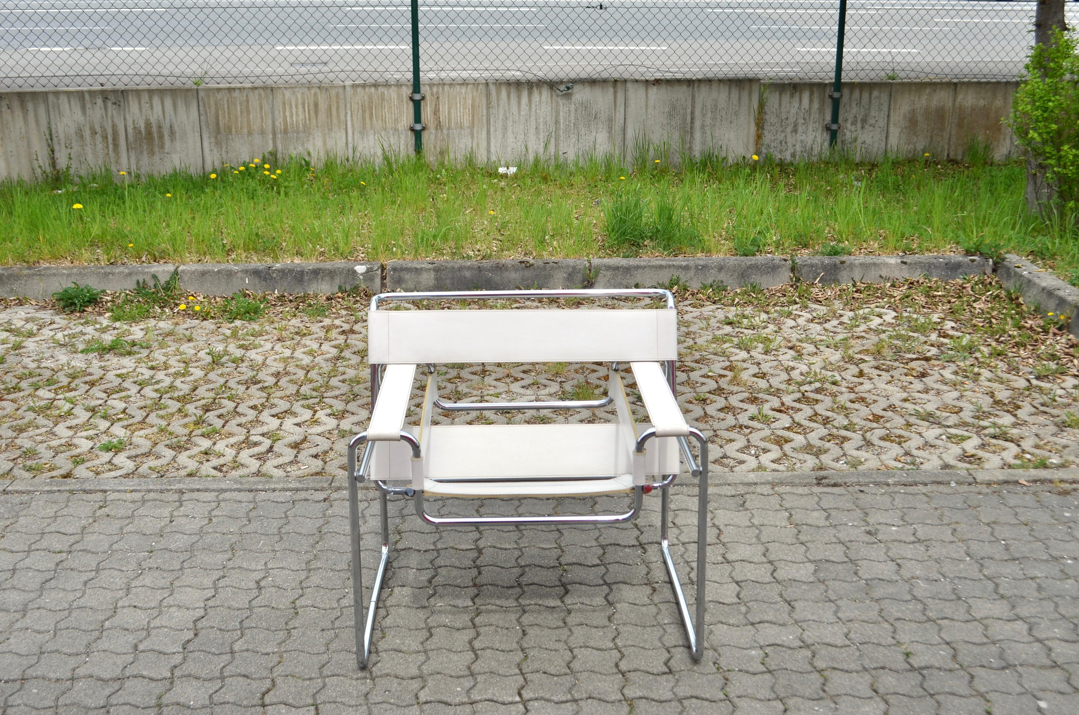 This old Vintage Wassily chair Model B3, in chromed tubular steel and white leather, was designed by Marcel Breuer and produced by Gavina.
It's an early edition before 68. 
The Marcel Breuer Stamp on the leather is underneath the leather seat, see
