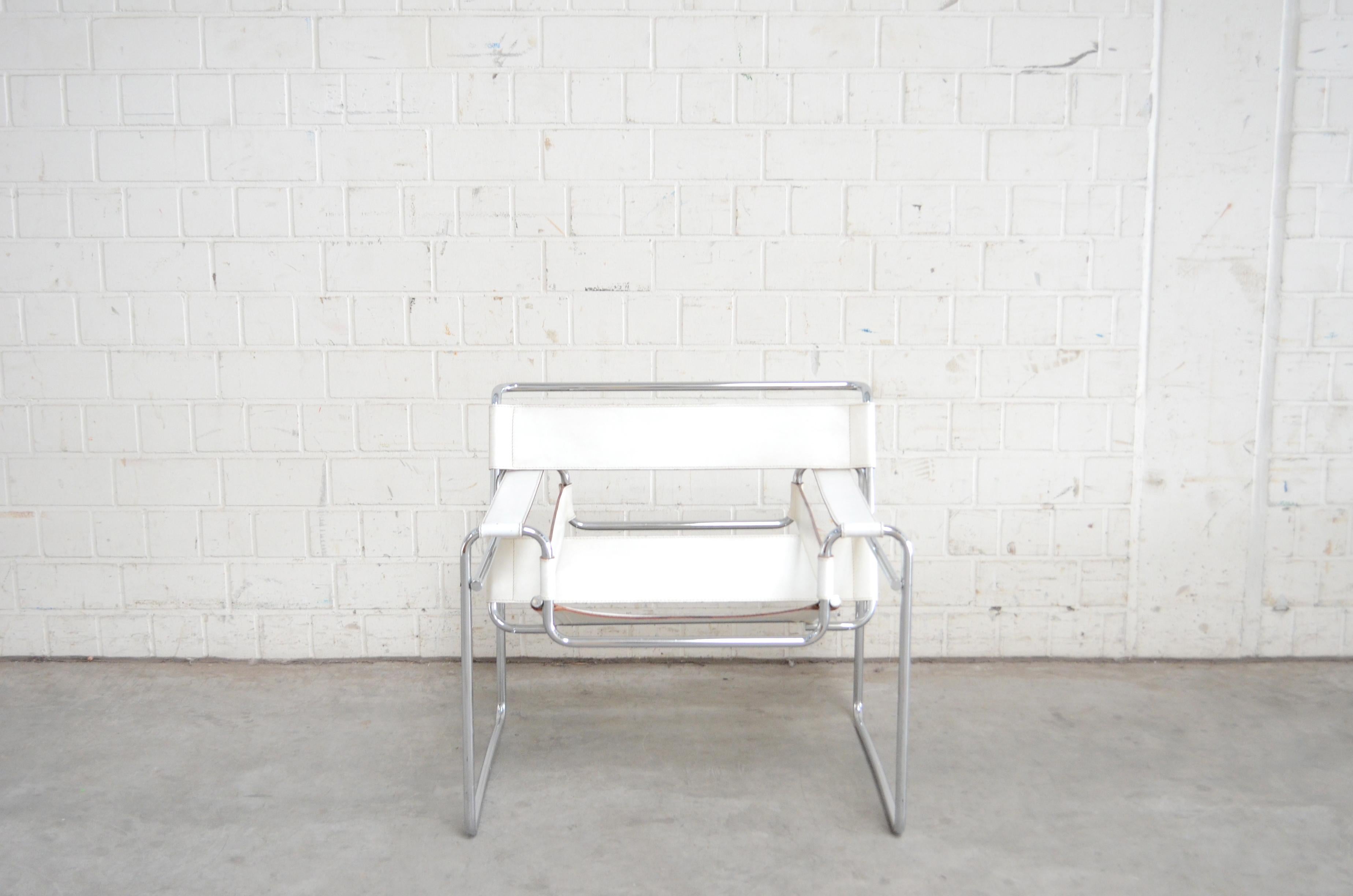 This Wassily chair, in chromed tubular steel and white leather, was designed by Marcel Breuer and produced by Gavina.
It's an early edition before 68 with the stamp underneath the seat. It has some marks on the leather seat.
 