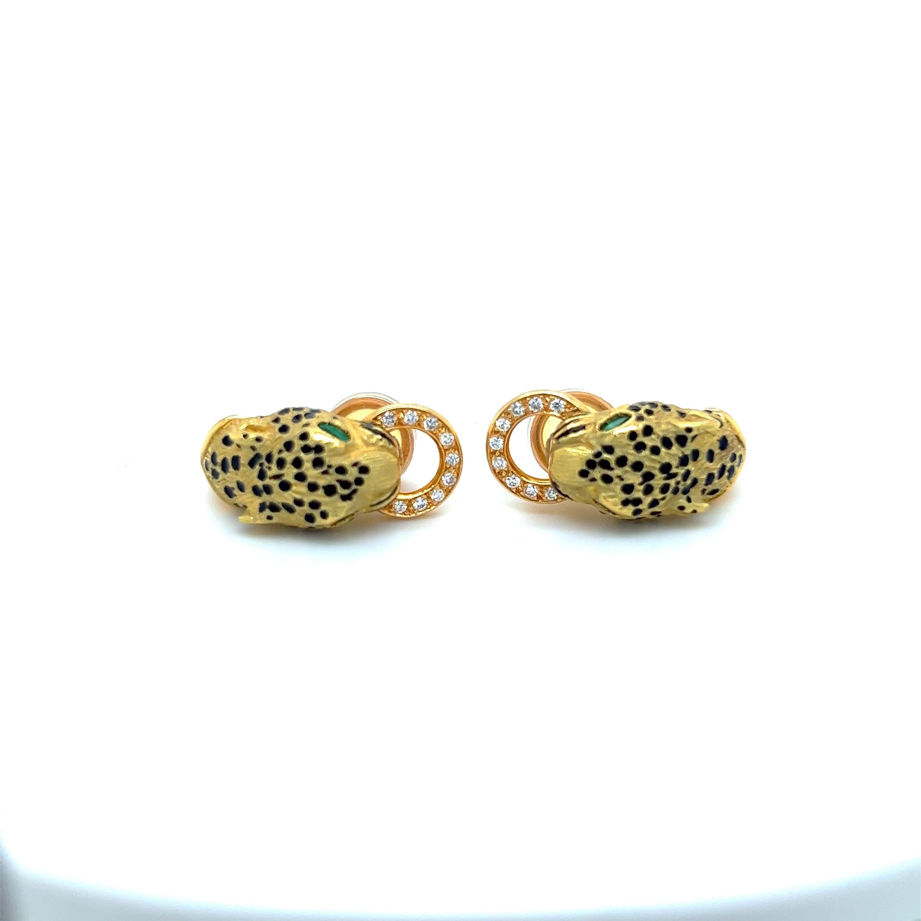 Beautiful 18 kt yellow gold Panther earrings. The earrings are designed with black enamel spots and set with marquise shaped emeralds as the eyes. The Panther holds a diamond ring in his mouth.
The earrings are clip on, but  posts may be