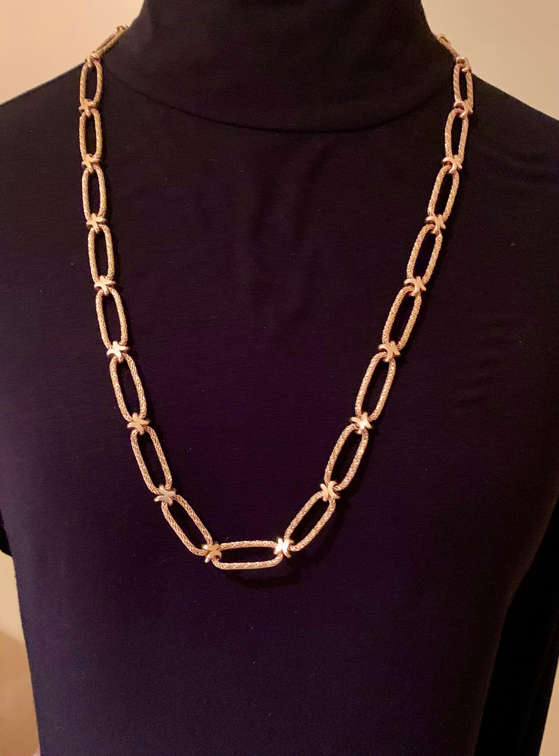 Rare estate Gay Freres 18K woven yellow gold long chain X link necklace convertable to a lariat necklace, a double necklace, belt and quad bracelet. The X link design is a universal symbol of love, indicative of a kiss.
France
1980's
Marks: Gay