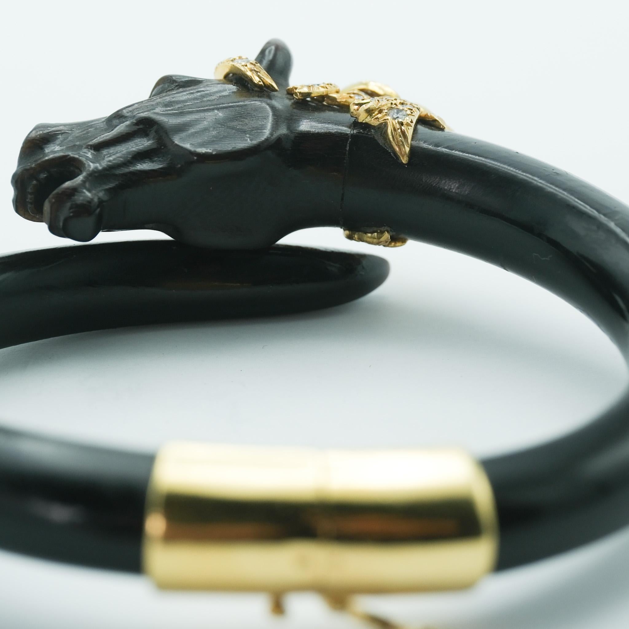 The Gay Frères ebony horse bangle bracelet is an extraordinary testament to the precision and artistry of French jewelry design. Crafted from smoothly polished ebony wood, the bracelet features a meticulously carved stallion head, with a beautiful