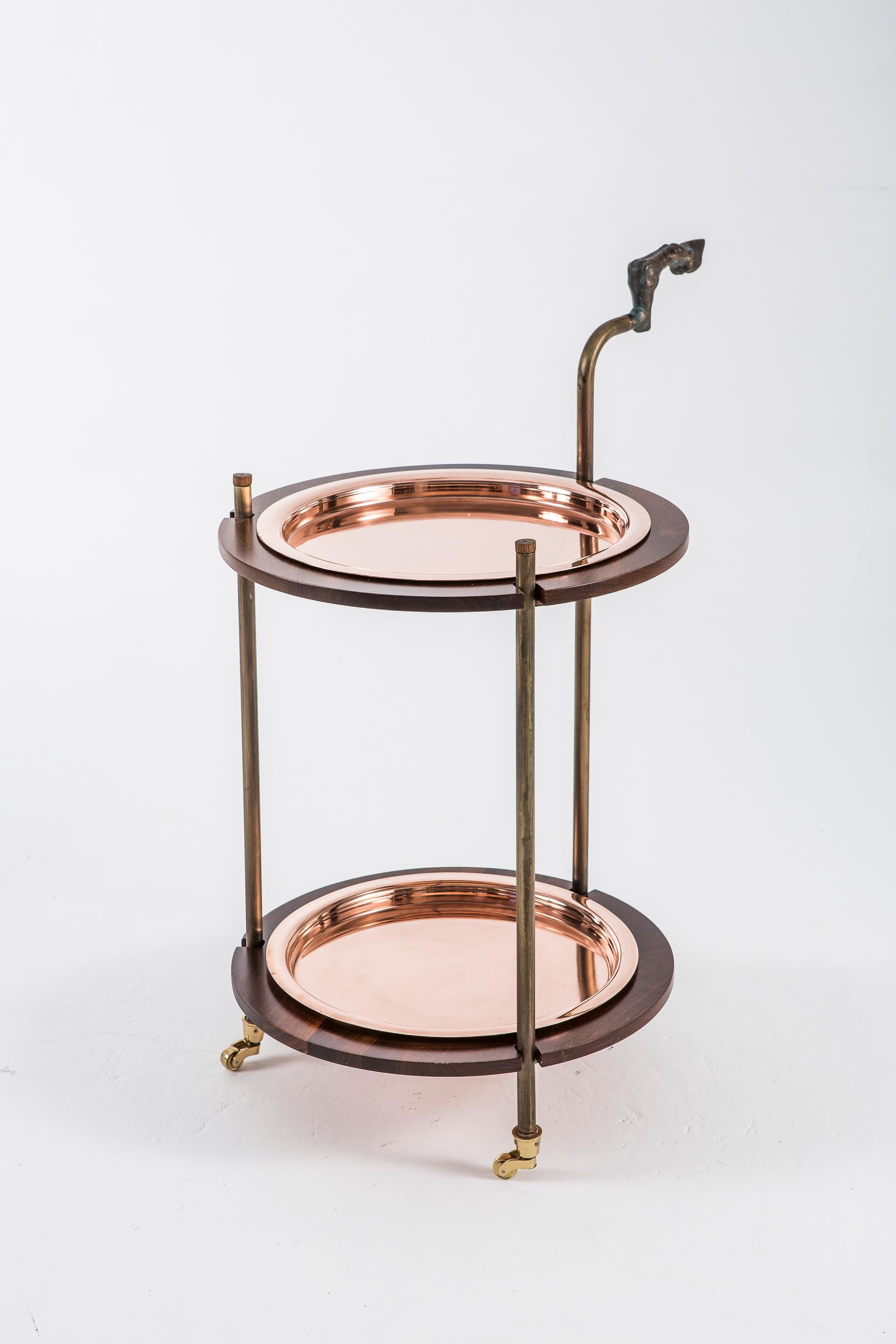 Gazelle drinks trolley by Egg Designs
Dimensions: 55 L X 74 W X 100 H cm
Materials: Solid Walnut, Copper, Composite Casting

Founded by South Africans and life partners, Greg and Roche Dry - Egg is a unique perspective in contemporary furniture