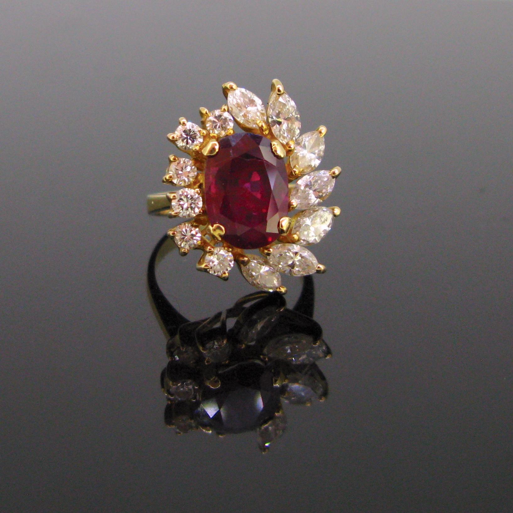 This cluster ring is set with a deep red ruby weighing around 3.5ct. It has been tested by GCS lab as a Thailand with no indication of heating. It is surrounded with 7 marquise cut diamonds and with 6 round cut diamonds. The ring is fully made in