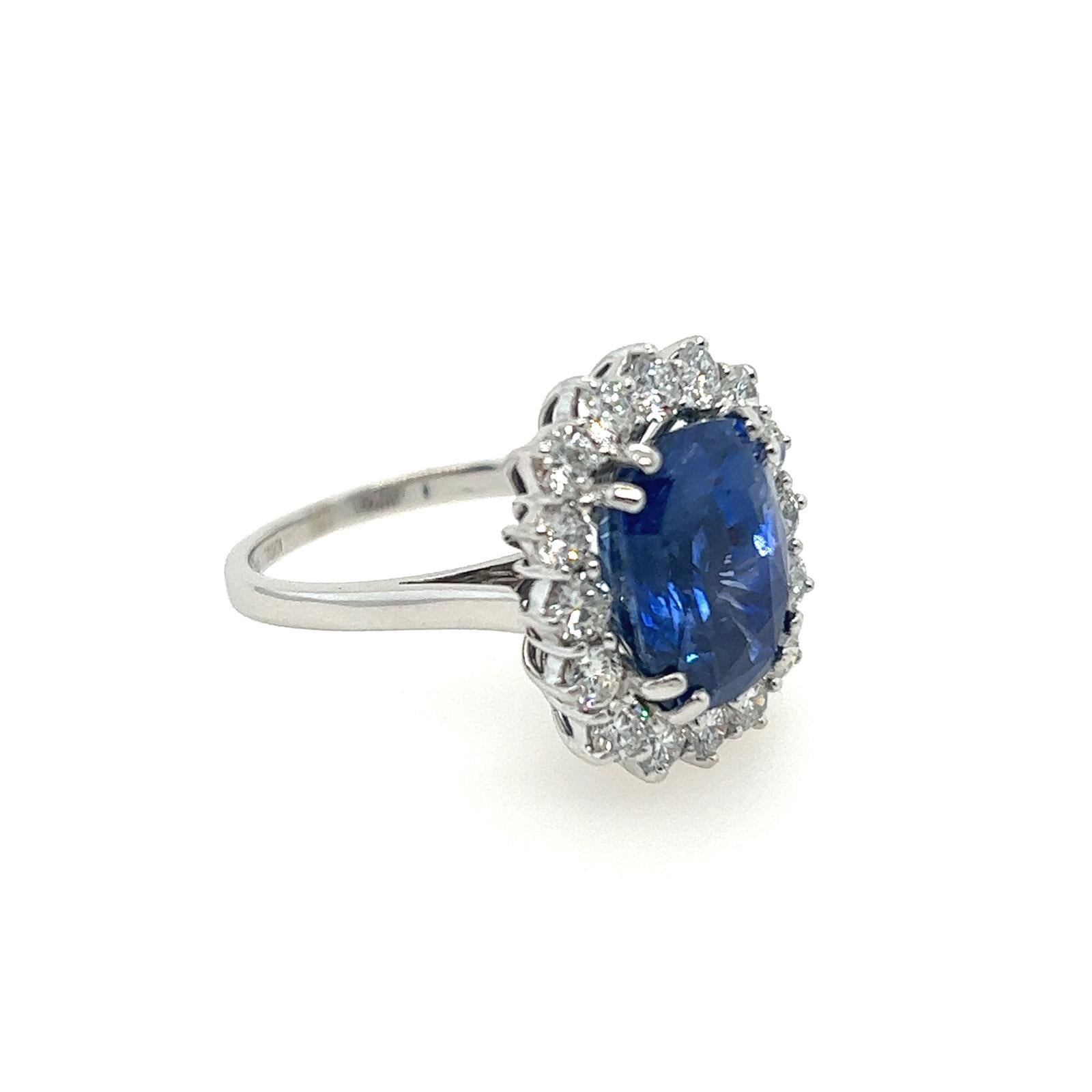 GCS Certified 8.57 Carat Ceylon Sapphire and Diamond Cluster Ring in 18K White Gold.

This magnificent masterpiece features a majestic Cushion cut GCS Certified Blue Sapphire at its centre. Weighing 8.57 Carats, this spectacular stone originates