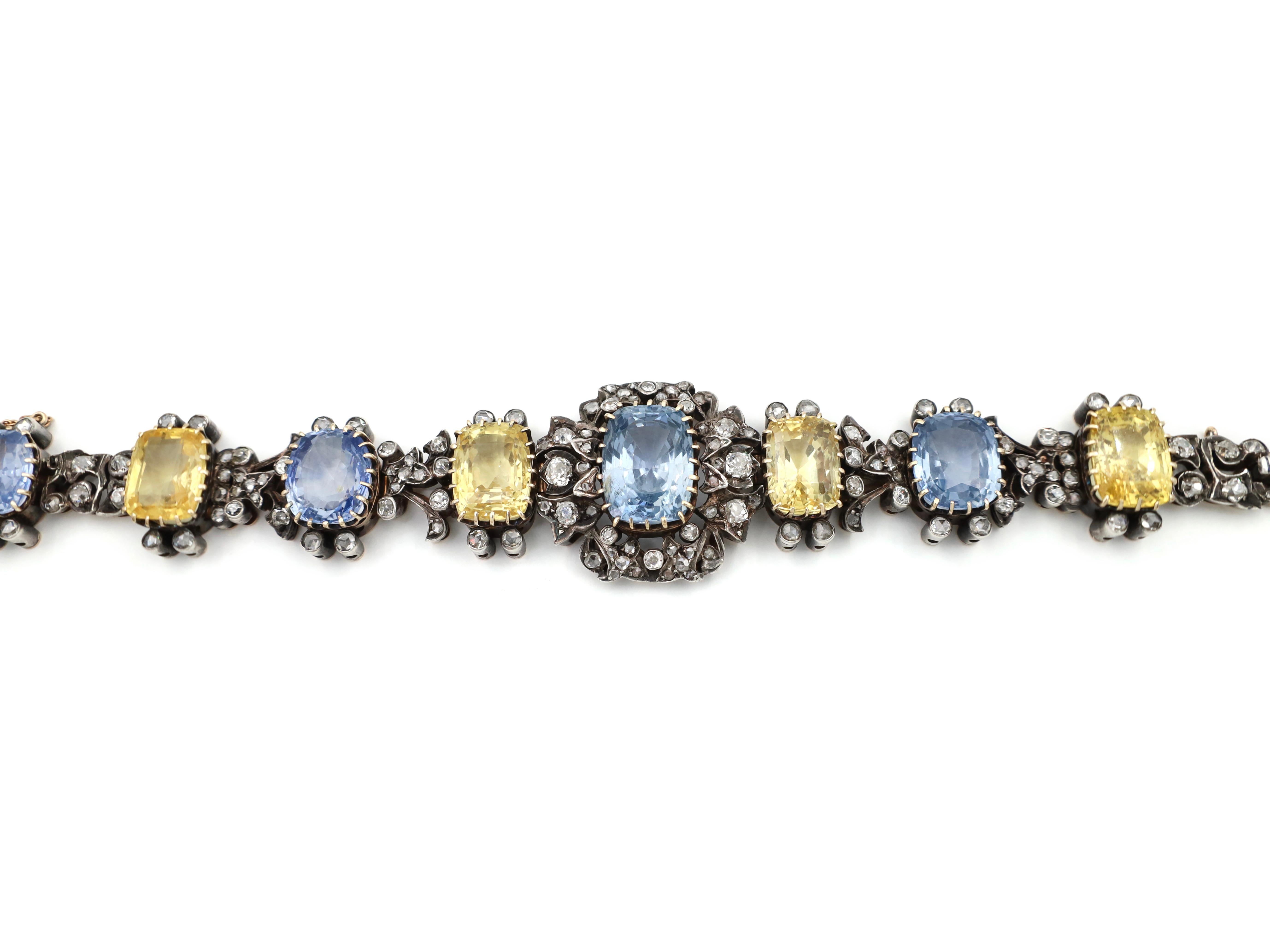 French antique Ceylon cornflower blue and fancy yellow sapphire bracelet in silver and gold. The central link is set with an estimated 20ct cushion shape fancy cut Ceylon sapphire with no indication of heat treatment in a raised gold claw setting,
