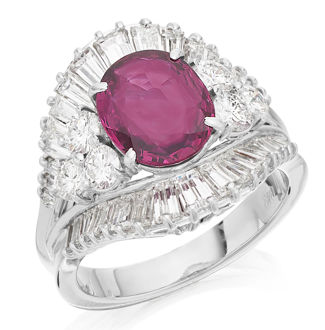 Gorgeous ruby and diamond ring in 18K white gold, centering a stunning oval cut deep red ruby with 3 round brilliant diamonds on the both sides, all bordered by two crowns, above and below of baguette cut diamonds all on a unique arrowhead band.
1 x