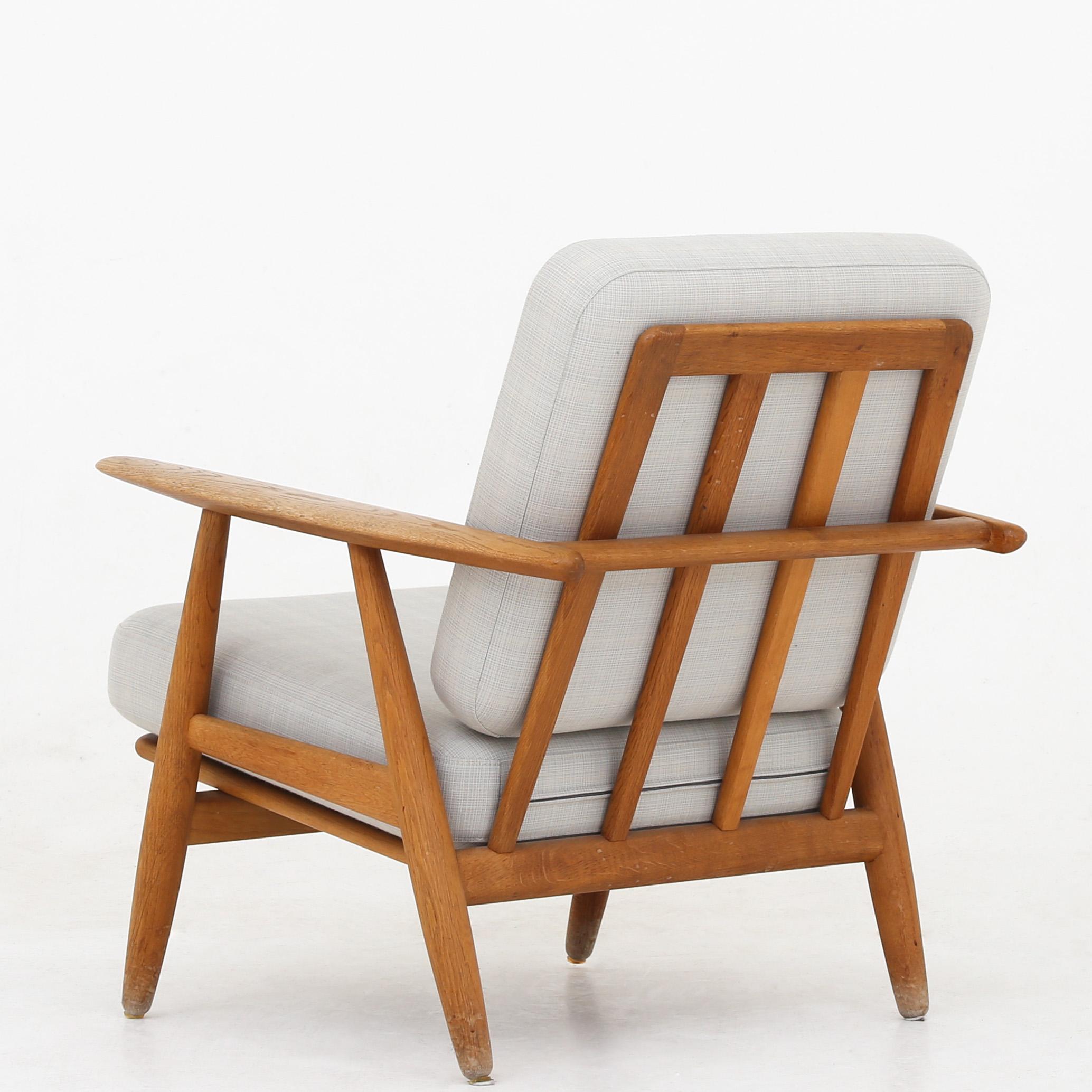 Hans J. Wegner GE 240 - 'Cigar' easy chair in solid, patinated oak and cushions in light wool. Maker Getama.