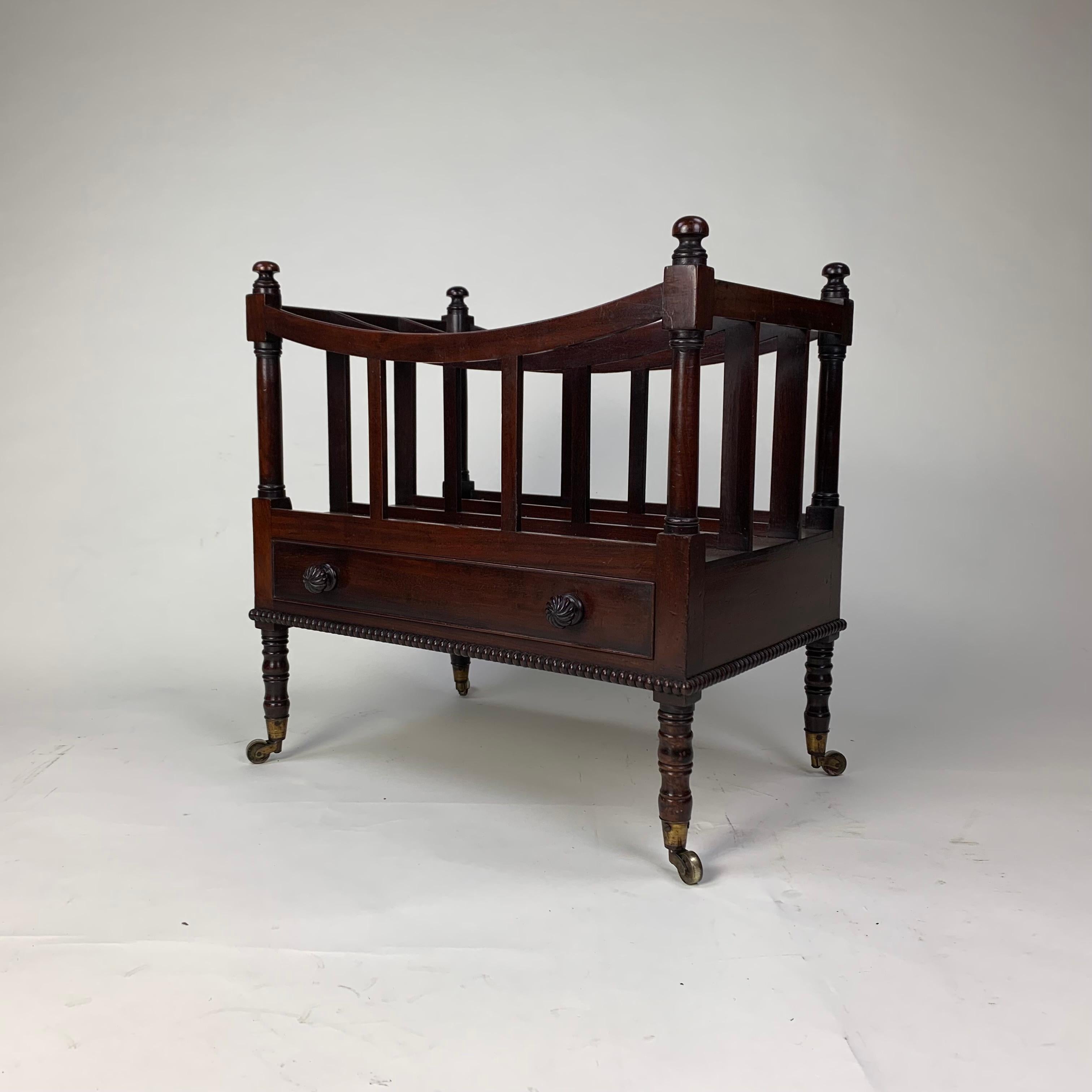 A perticularly fine example of an early 19th century mahogany four division Music Canterbury, with dished top supported on plain slats, above a single drawer and raised on elegant turned legs.
Retaining a delightful and very old label stuck inside