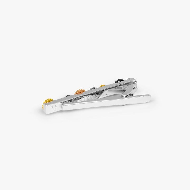 Gear Tie Clip with Multicoloured Gears

A line of multi-coloured spinning gears create a fun sense of movement to decorate your tie. Set in highly-polished, rhodium plated base metal. Perfect to accompany our iconic gear square cufflinks for a