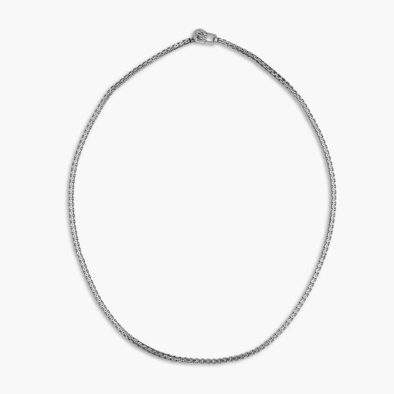 Gear Venetian Necklace in Black Rhodium Plated Sterling Silver

Our signature gear is held between an open rectangle frame and set onto a cut out Venetian chain. The perfect base to a layered look and for those who seek a bold statement. Set in